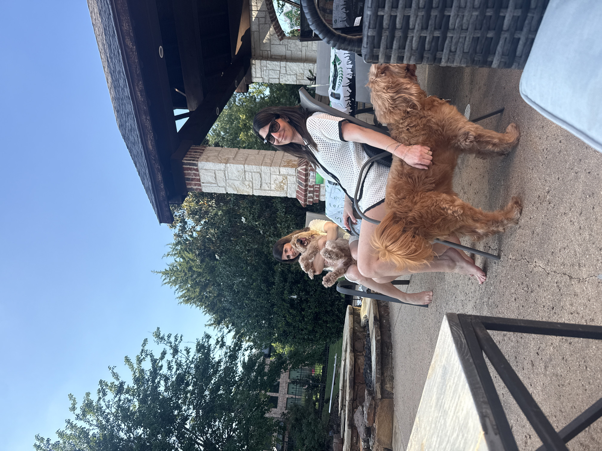 Woman enjoys evening with golden doodles in Southlake residence