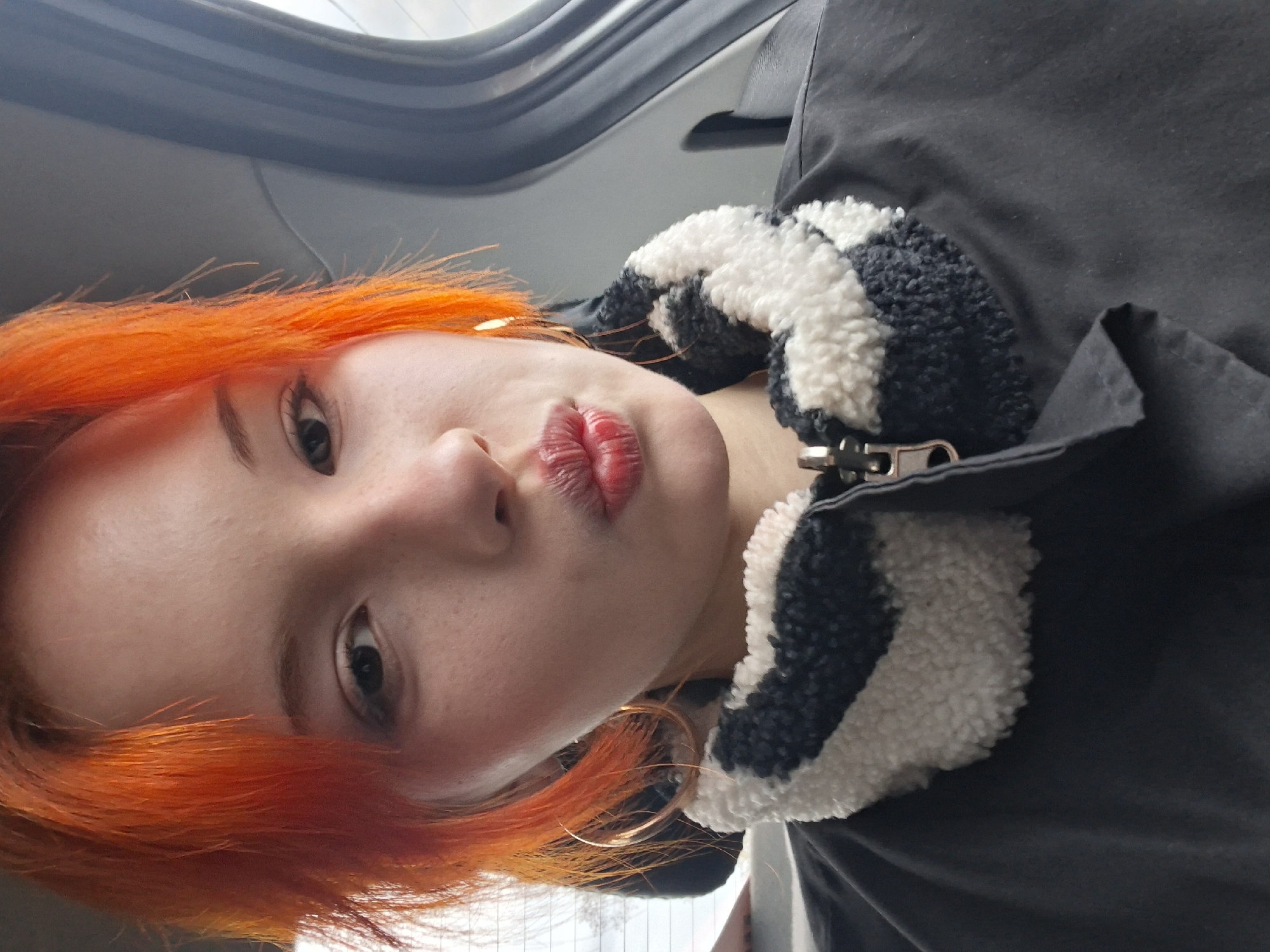 Orange-haired individual takes selfies in Chaikovsky, Russia
