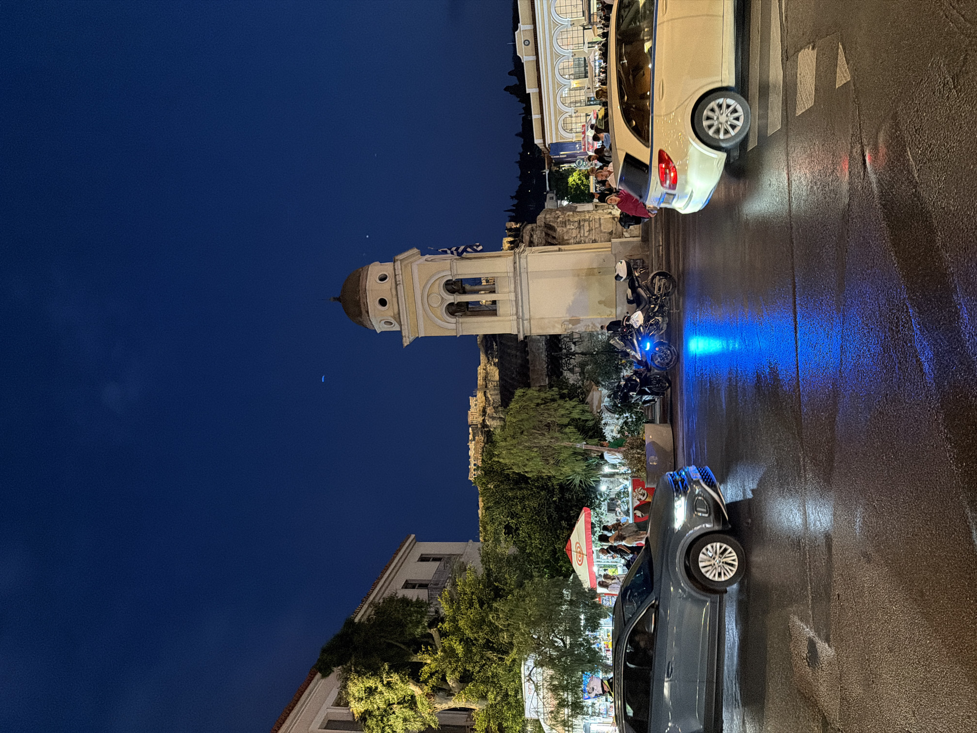 Evening scenes captured in Athens: illuminated church, coffee moment