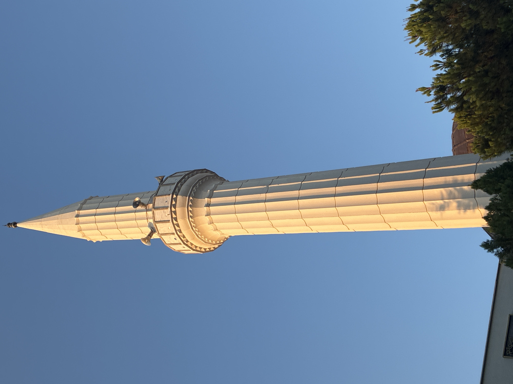 Golden hour minarets, a sleeping cat, and caged chickens in Alanya