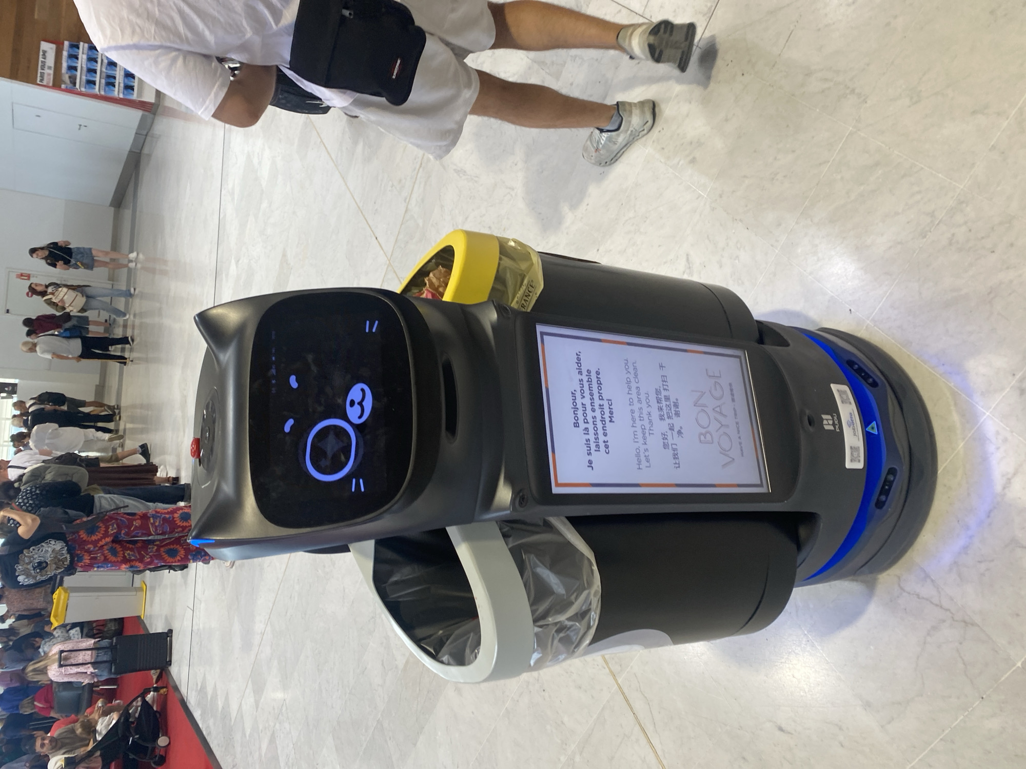 Robot bin and gate signage at CDG airport terminal