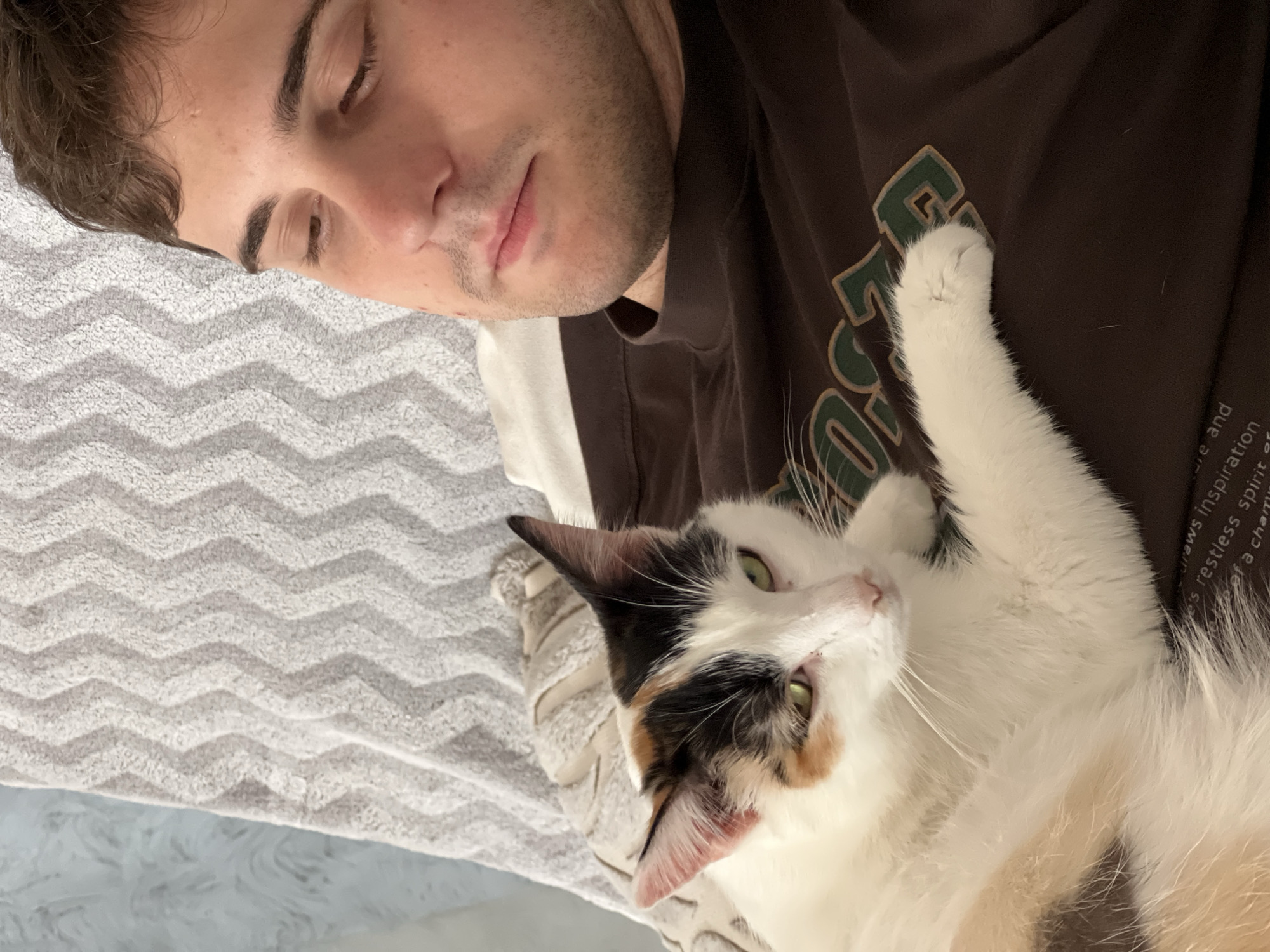 Family relaxes at home with cat in Rossiyskiy