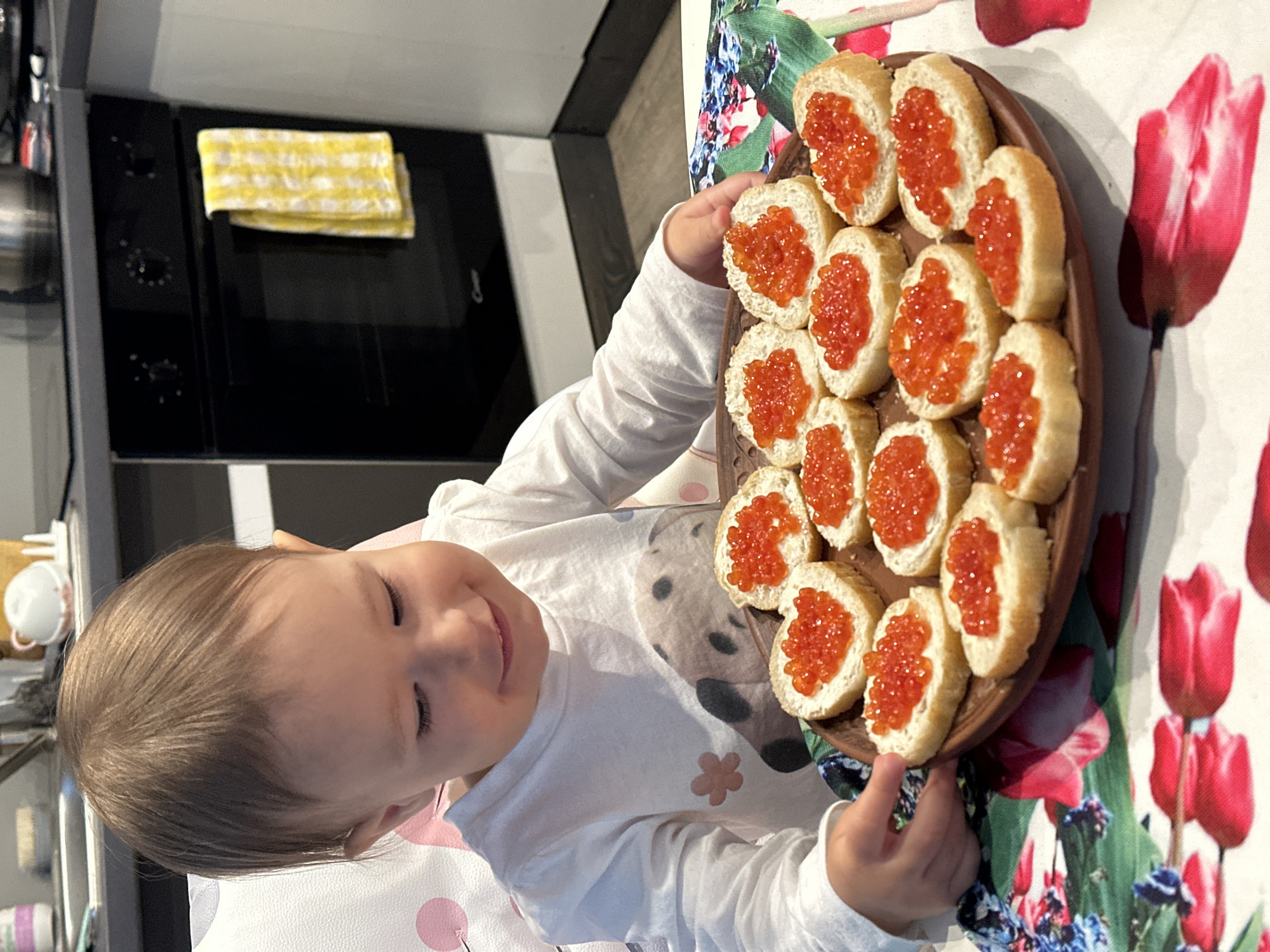 Child examines caviar-topped bread breakfast in Wisła, Poland