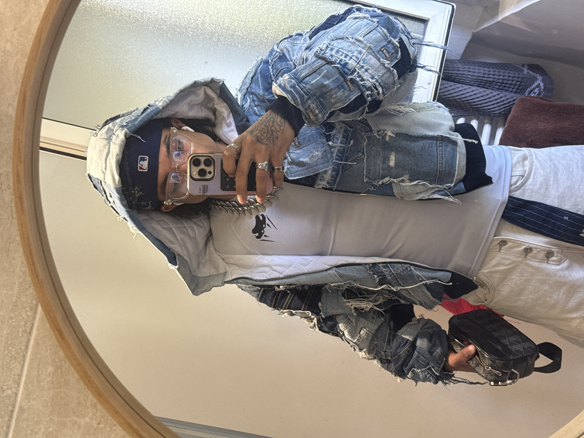 Person takes bathroom selfie in round mirror, Massy France