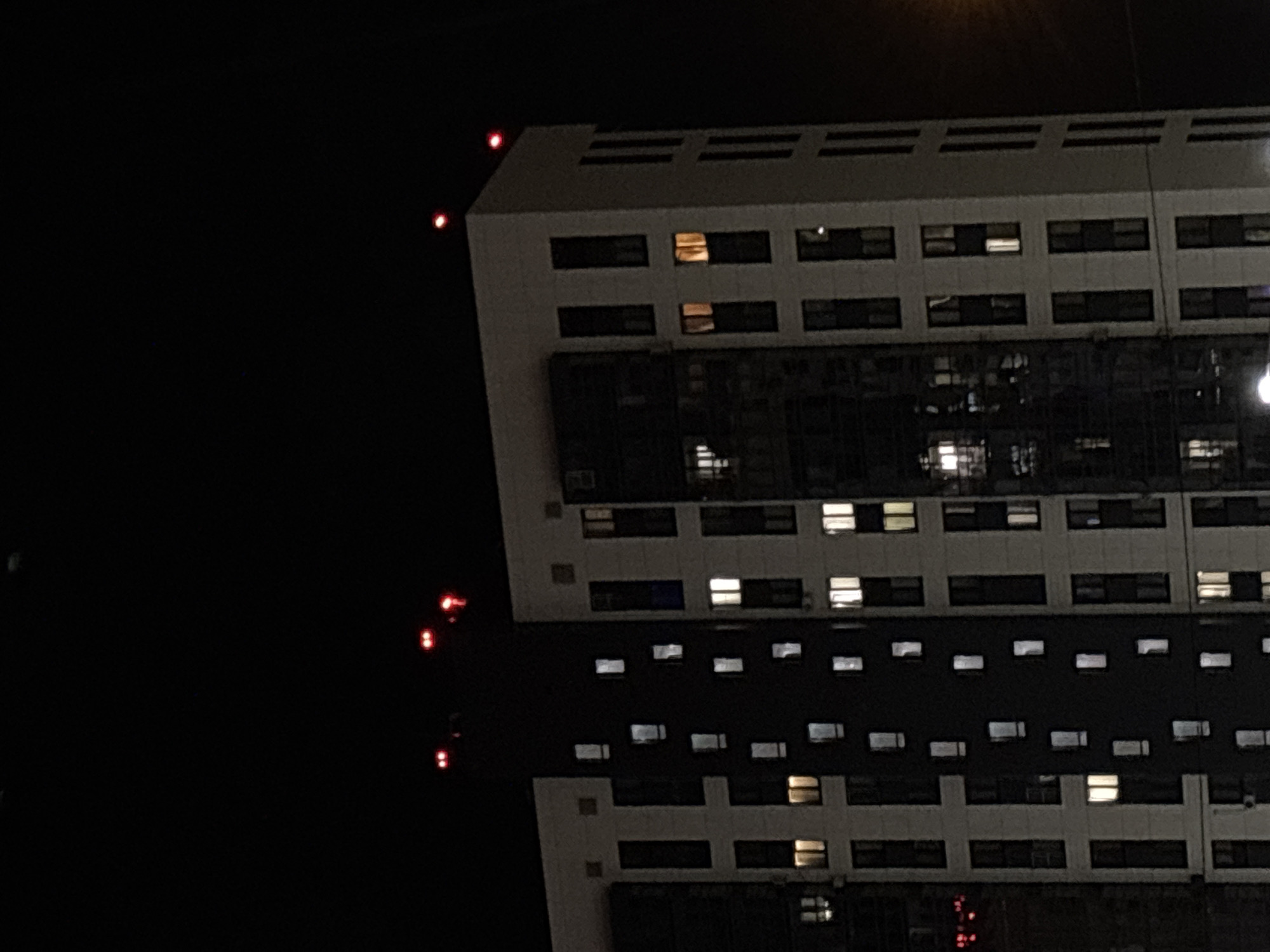 Kazan apartment building at night, with a fleeting green light