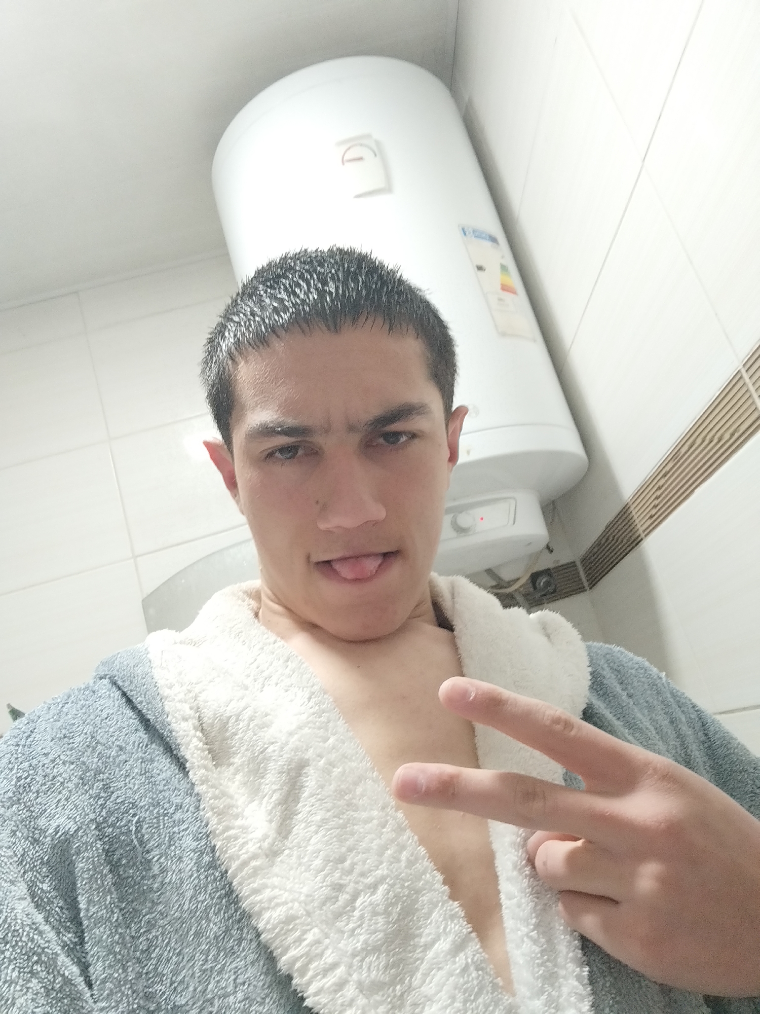 Person takes playful bathroom selfie in blue robe