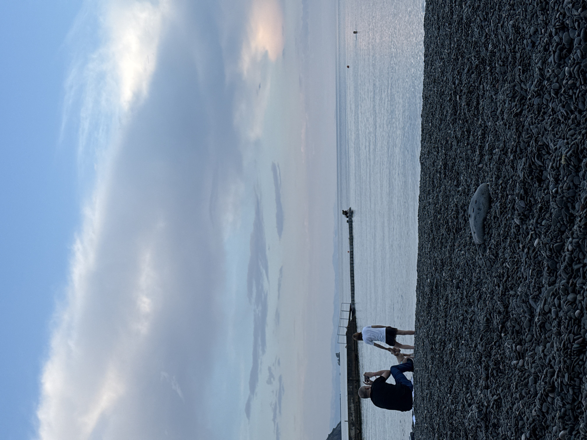Lazy summer evening on the pebble beach in Partenit