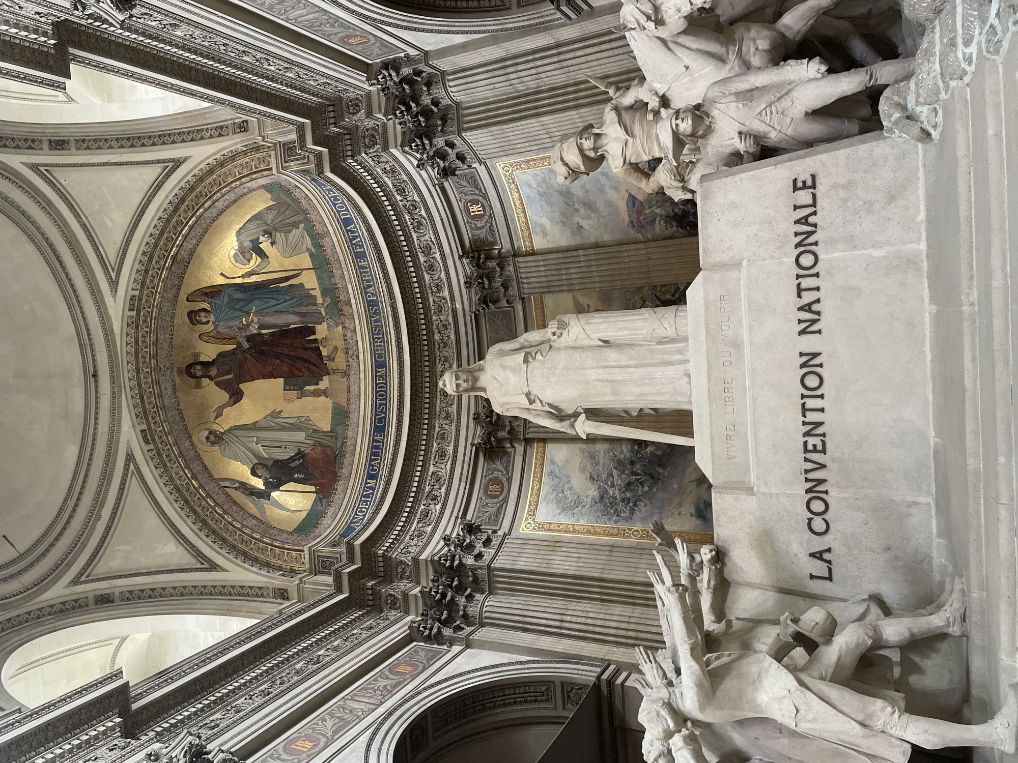 Visitor photographs La Convention Nationale statue at Paris Panthéon