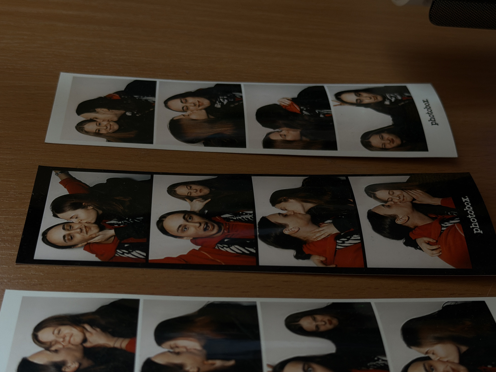 Photobooth strips of couple found on wooden surface