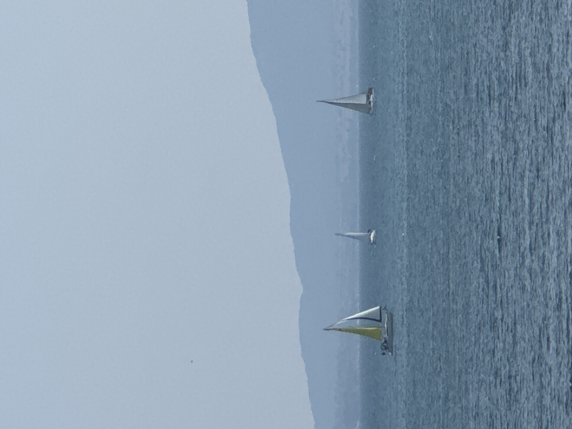 Three sailboats on calm Black Sea waters near Pomorie