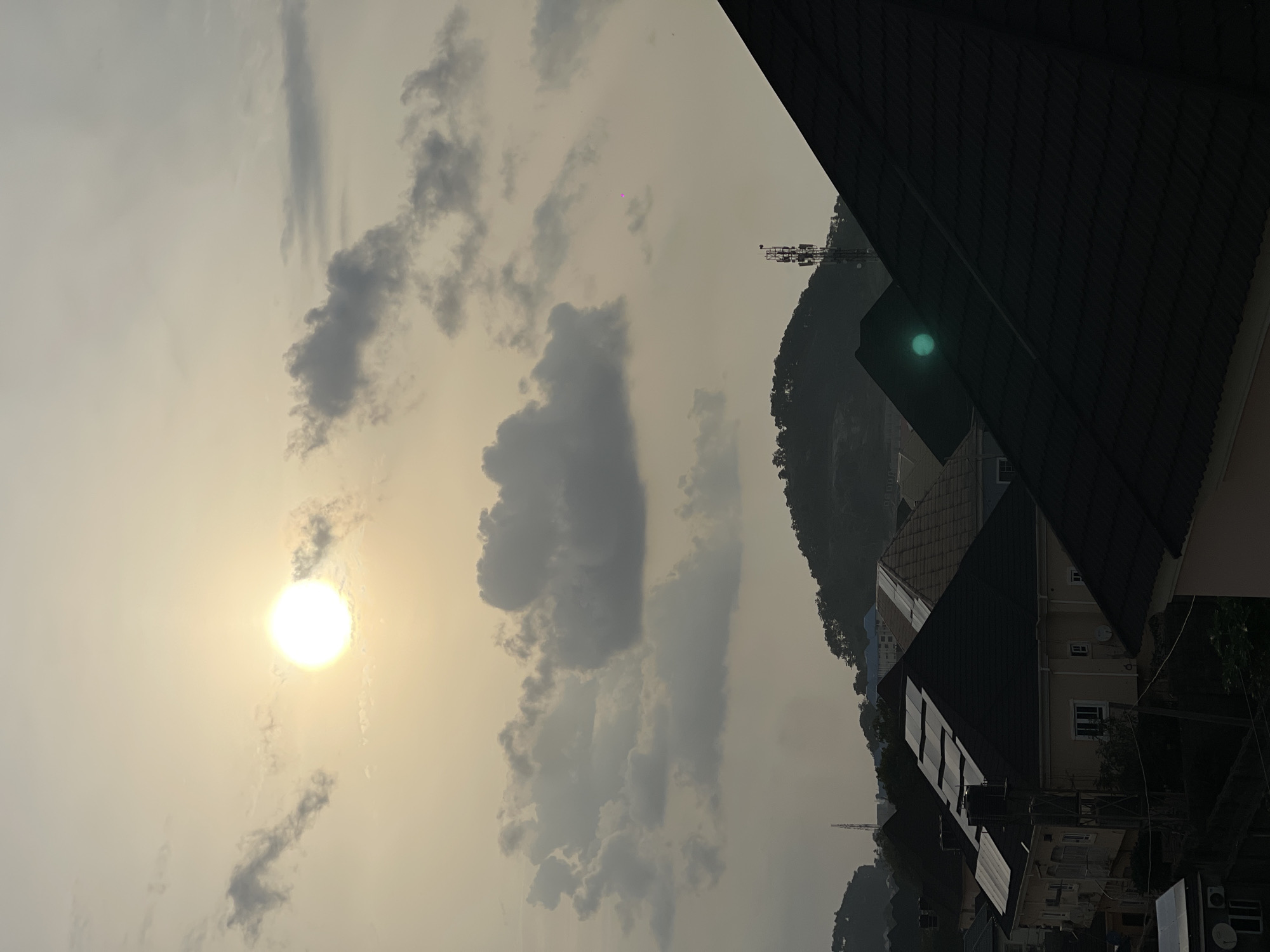 Hazy golden sunset settles over an Abuja residential neighborhood