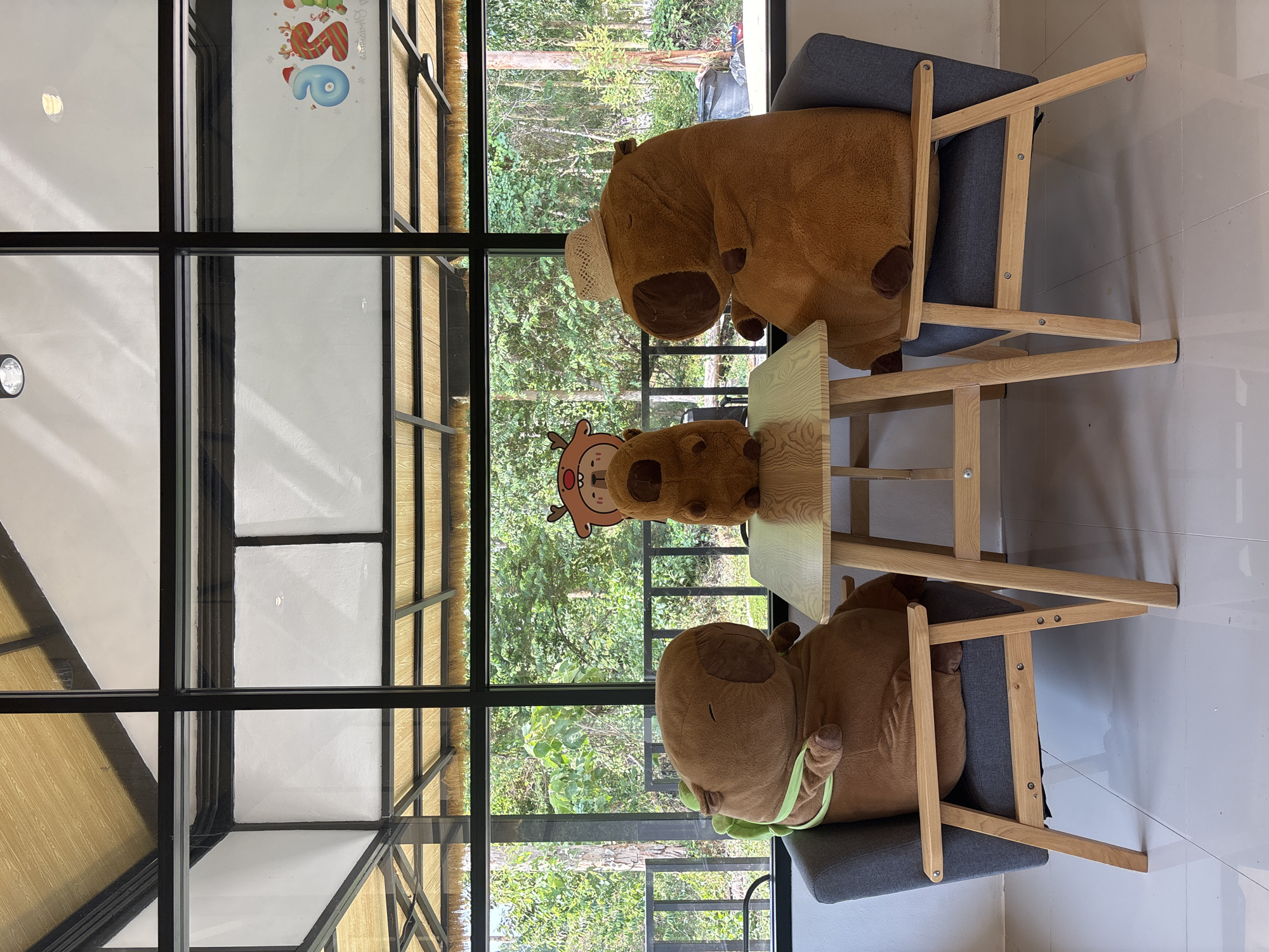 Capybara plush toys staged at Thai cafe table