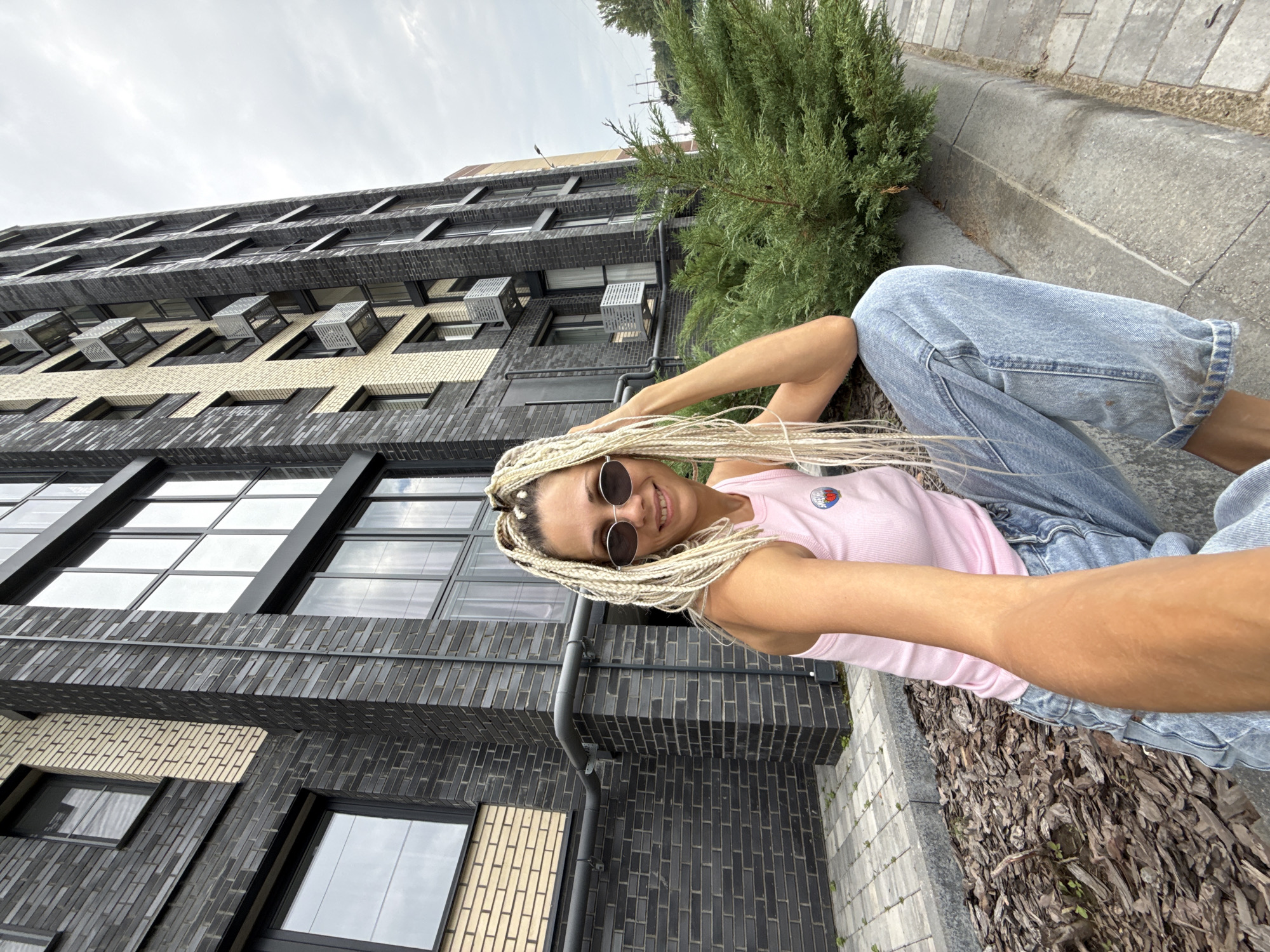Casual moments outside a modern brick building in Rusanovo