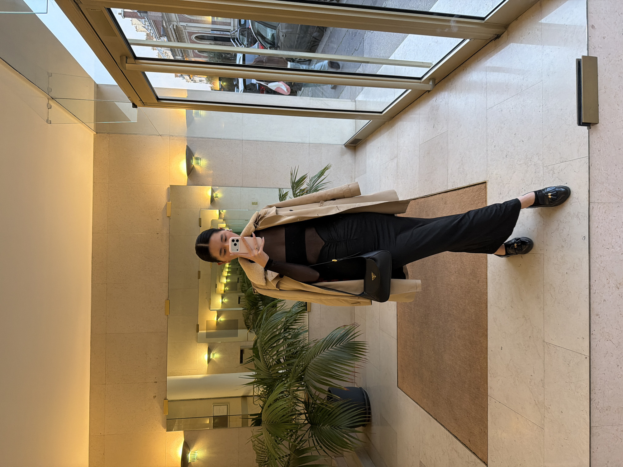 Woman takes selfie in Paris building lobby
