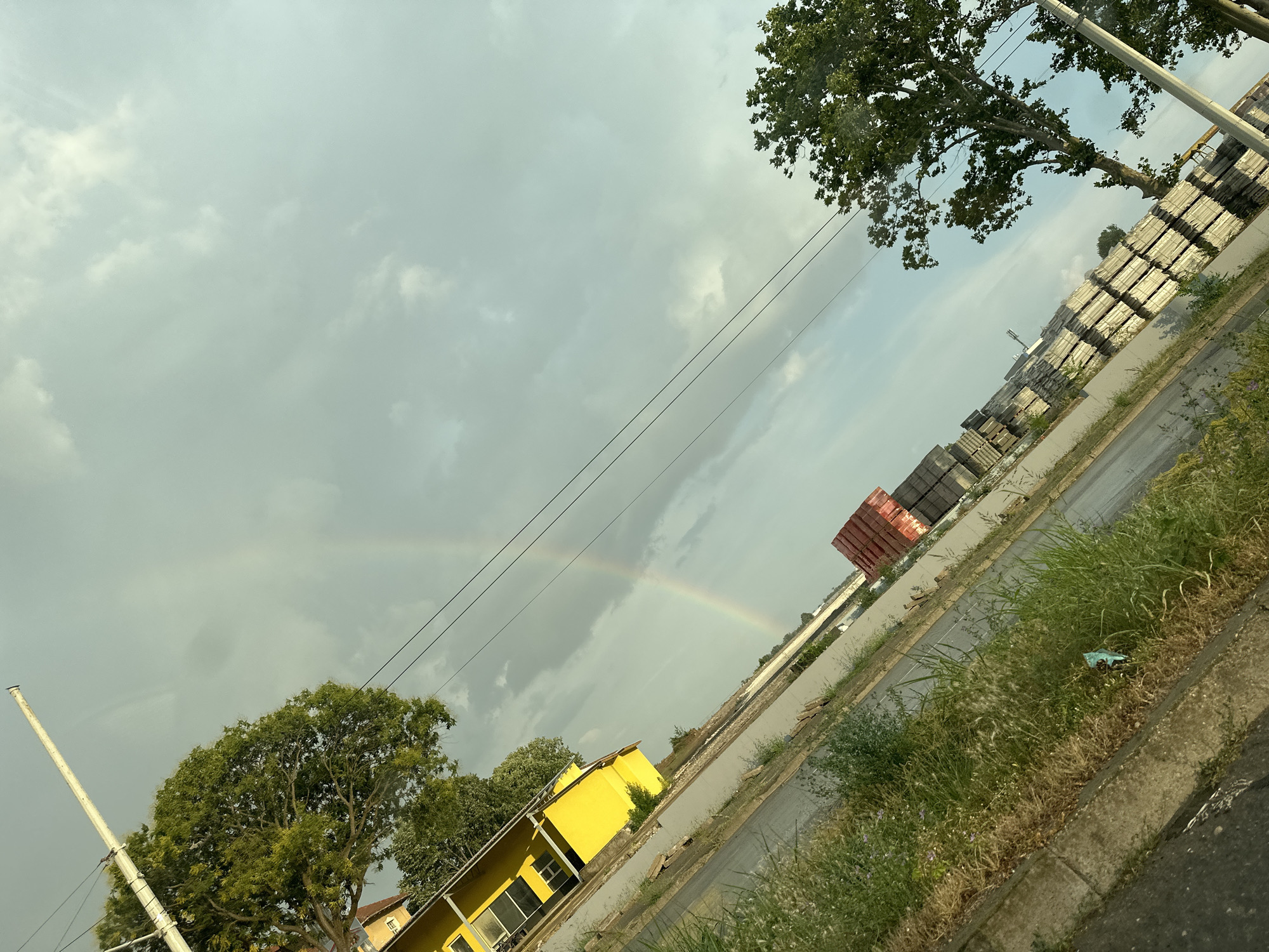 Wet streets and a faint rainbow in post-rain Ruse