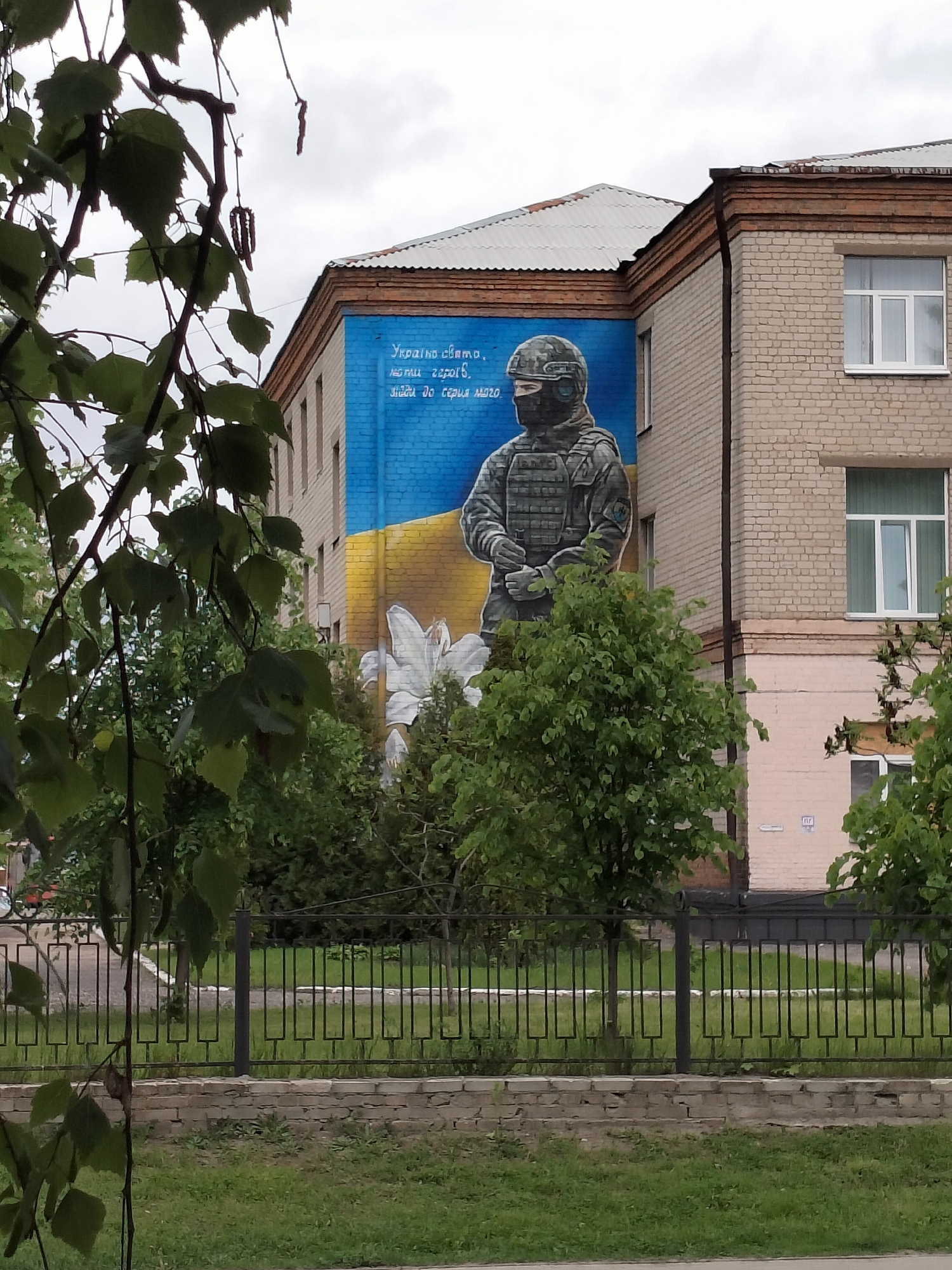 Ukrainian soldier mural spotted on brick building corner