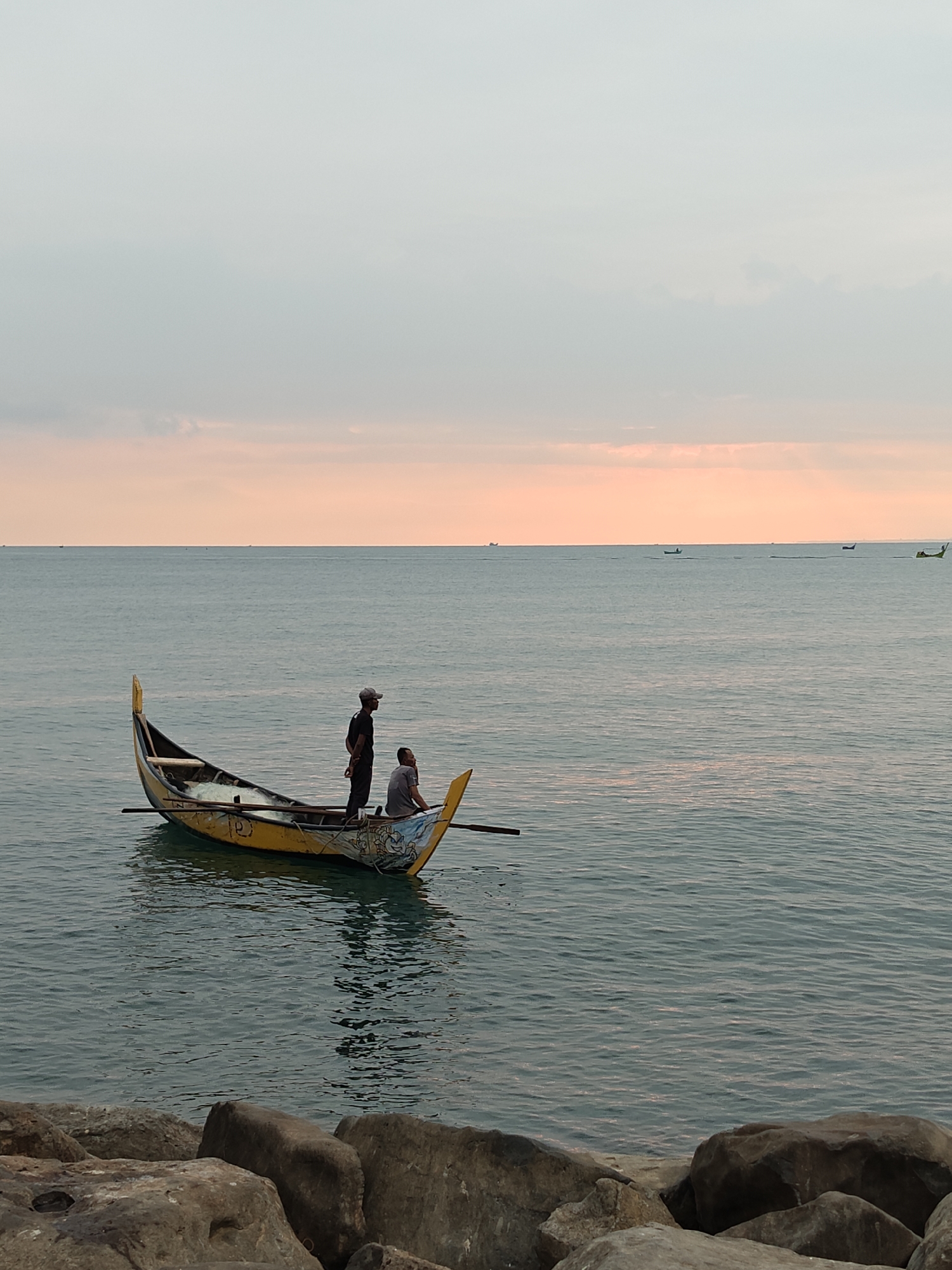 Traditional fishing boats spotted at sunset in Lhokseumawe waters