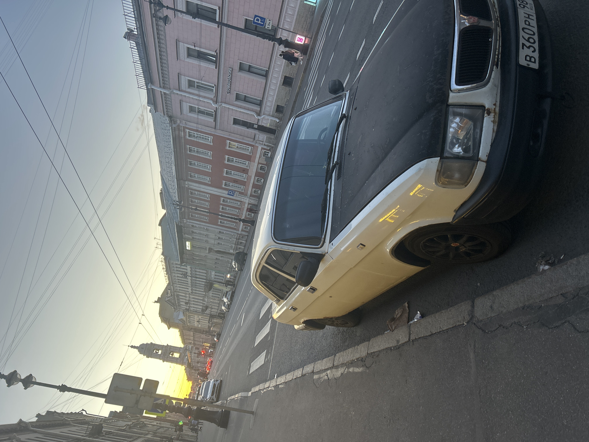 Evening street scene in a European city with ornate architecture
