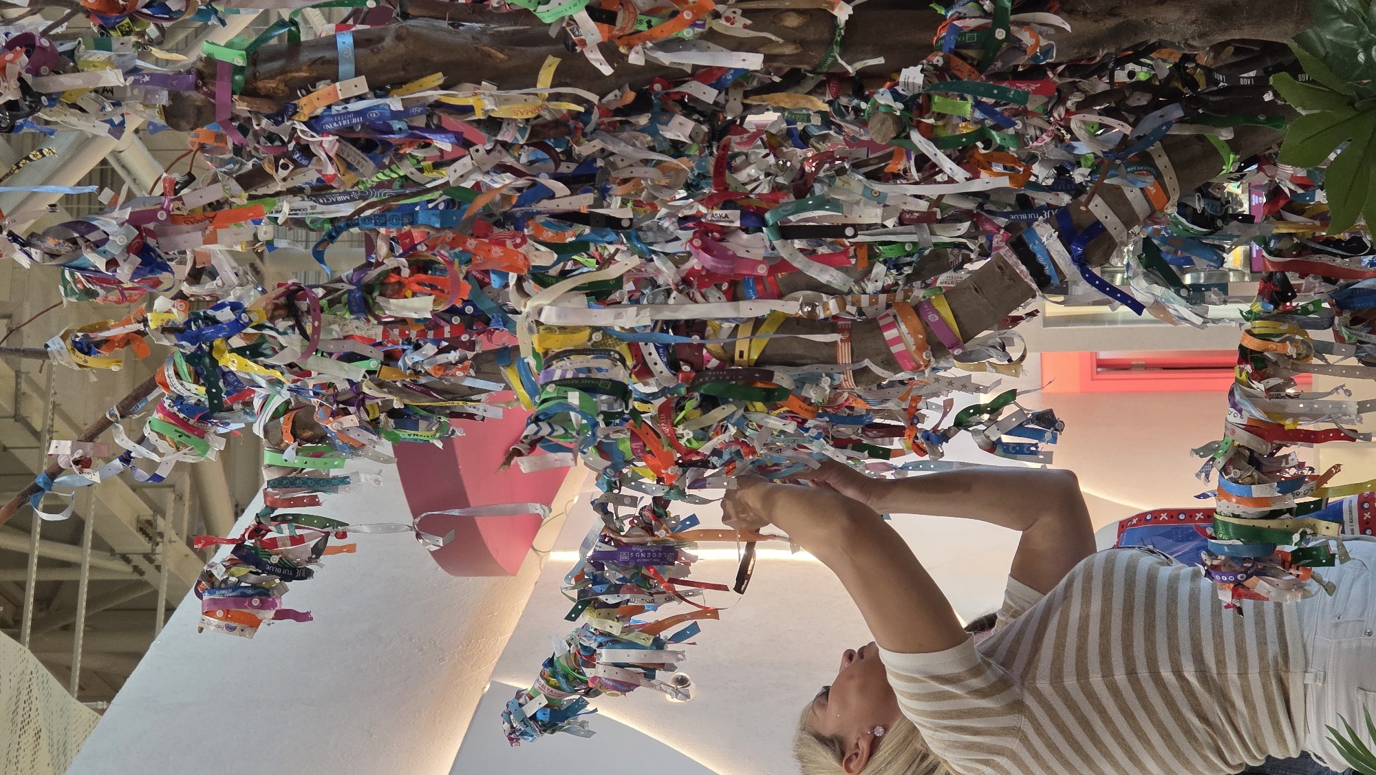 Woman adds wristband to colorful public art installation