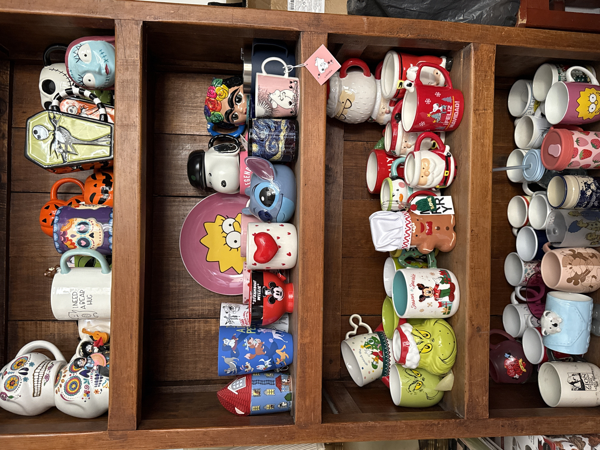 Collector showcases themed mug collection on wooden shelves in Puebla