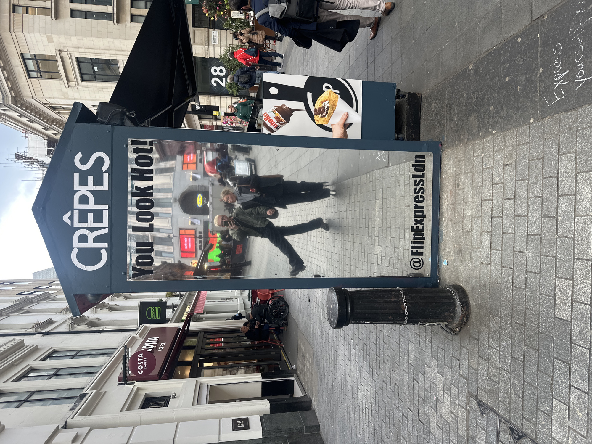London crêpe vendor displays flirty "You Look Hot!" sign