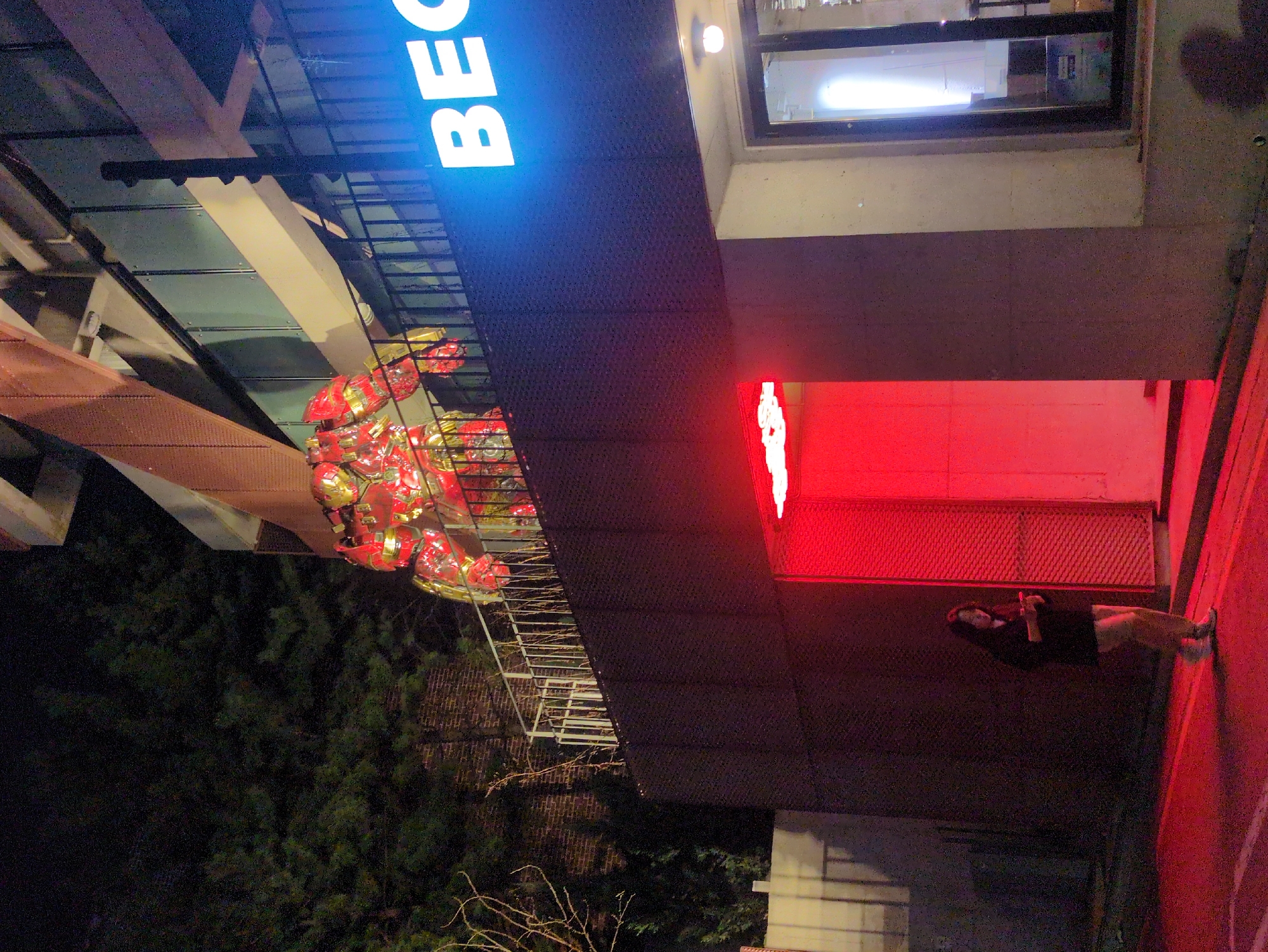 Woman with phone spotted under illuminated Seoul building signage