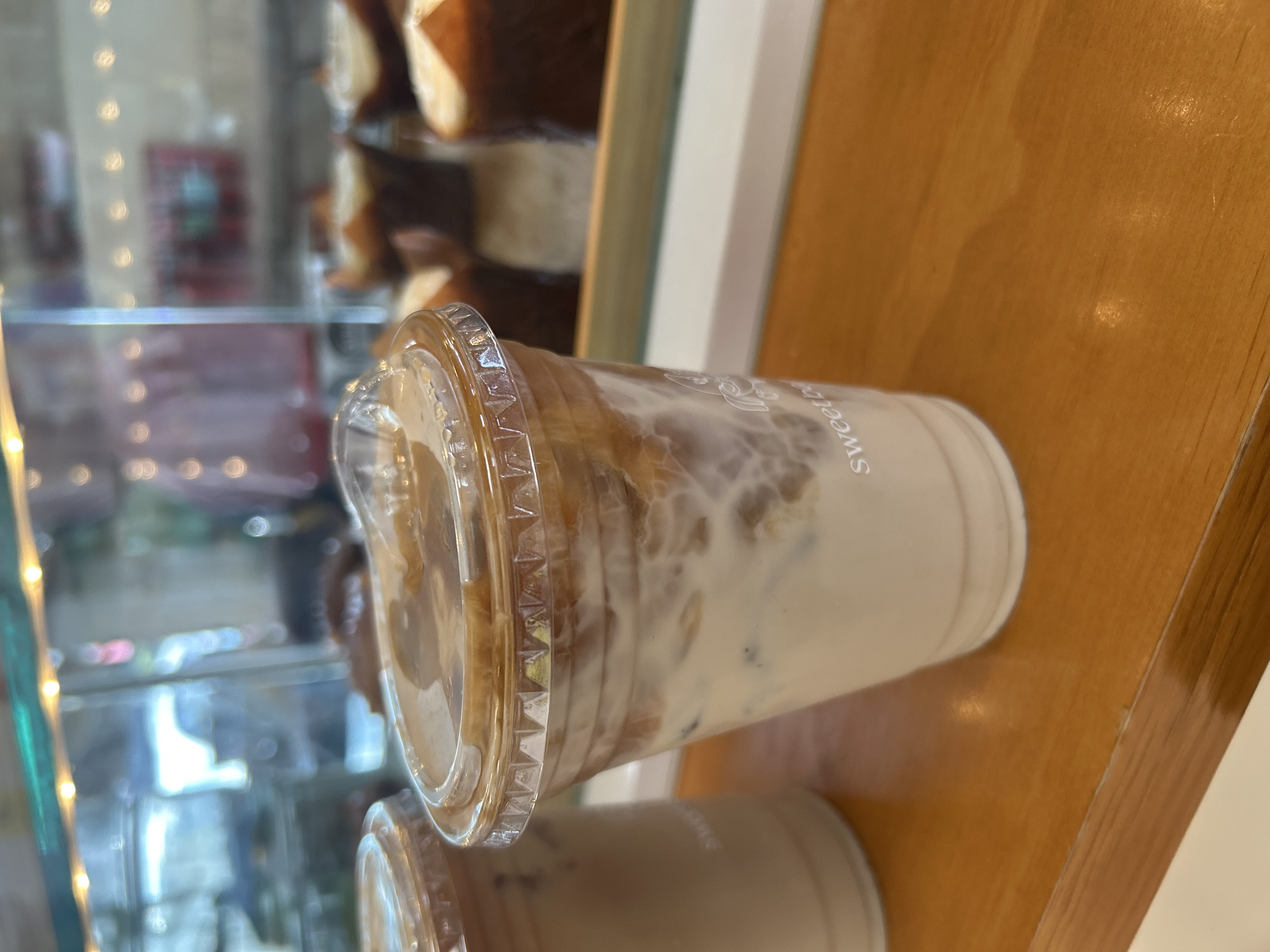 Cafe visit documented through coffee, pastries, art supplies