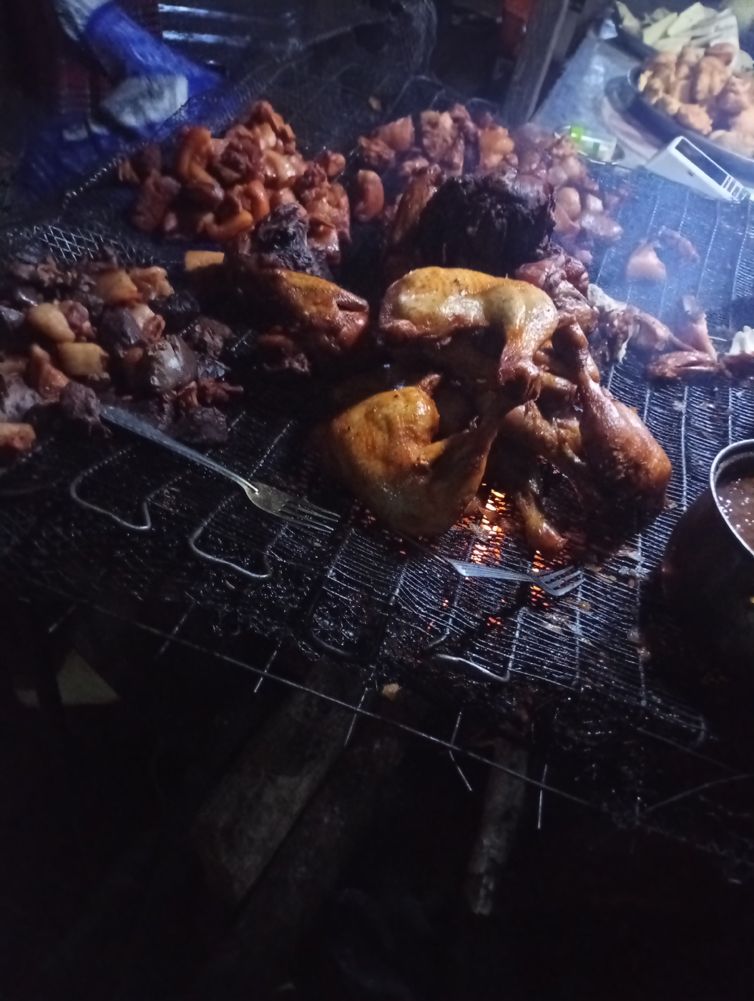 Meat on the grill and food stalls at a night market
