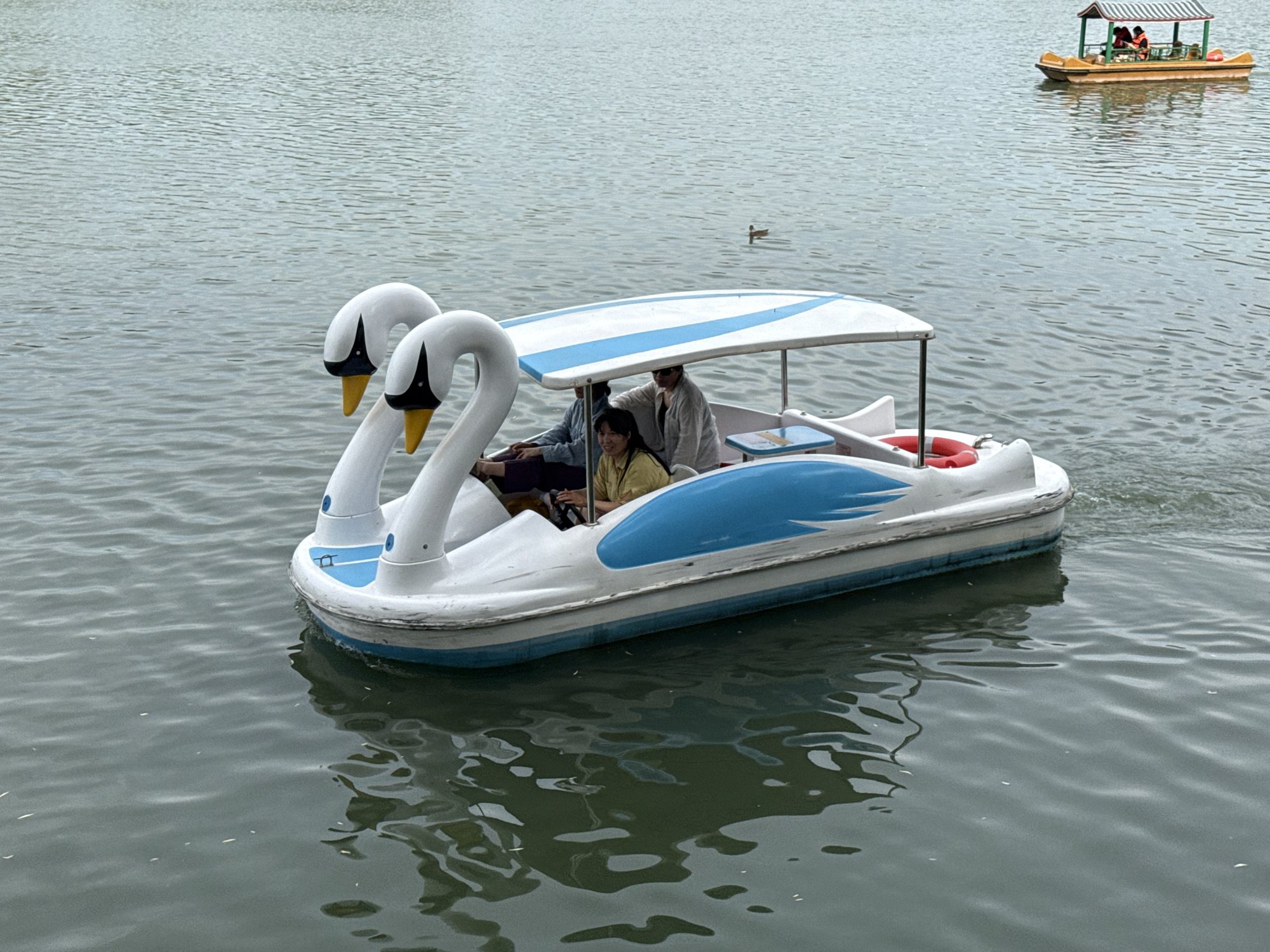 Beihai Park buzzes with boats and strollers on a summer morning