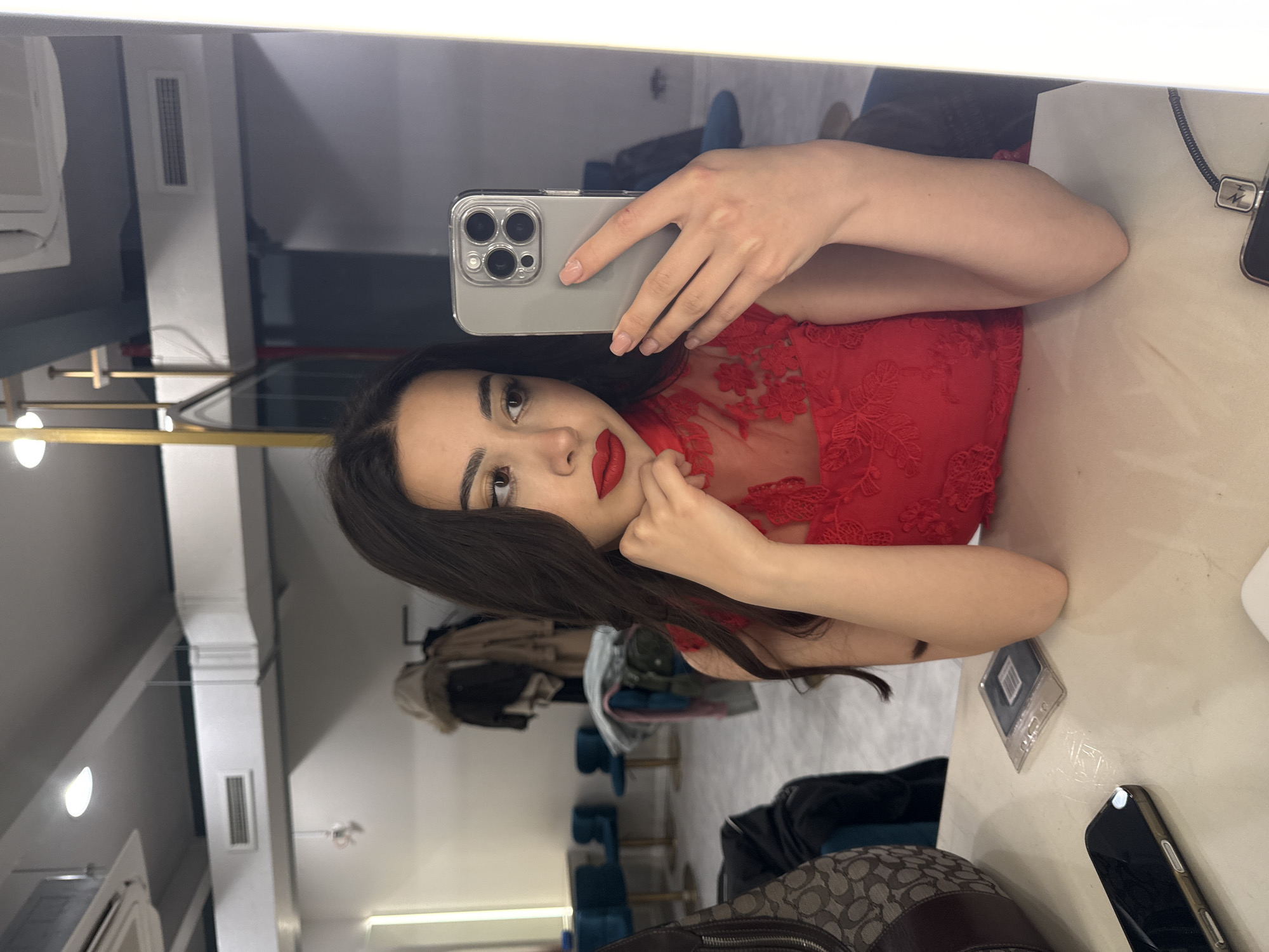 Woman takes mirror selfie in Yerevan interior location