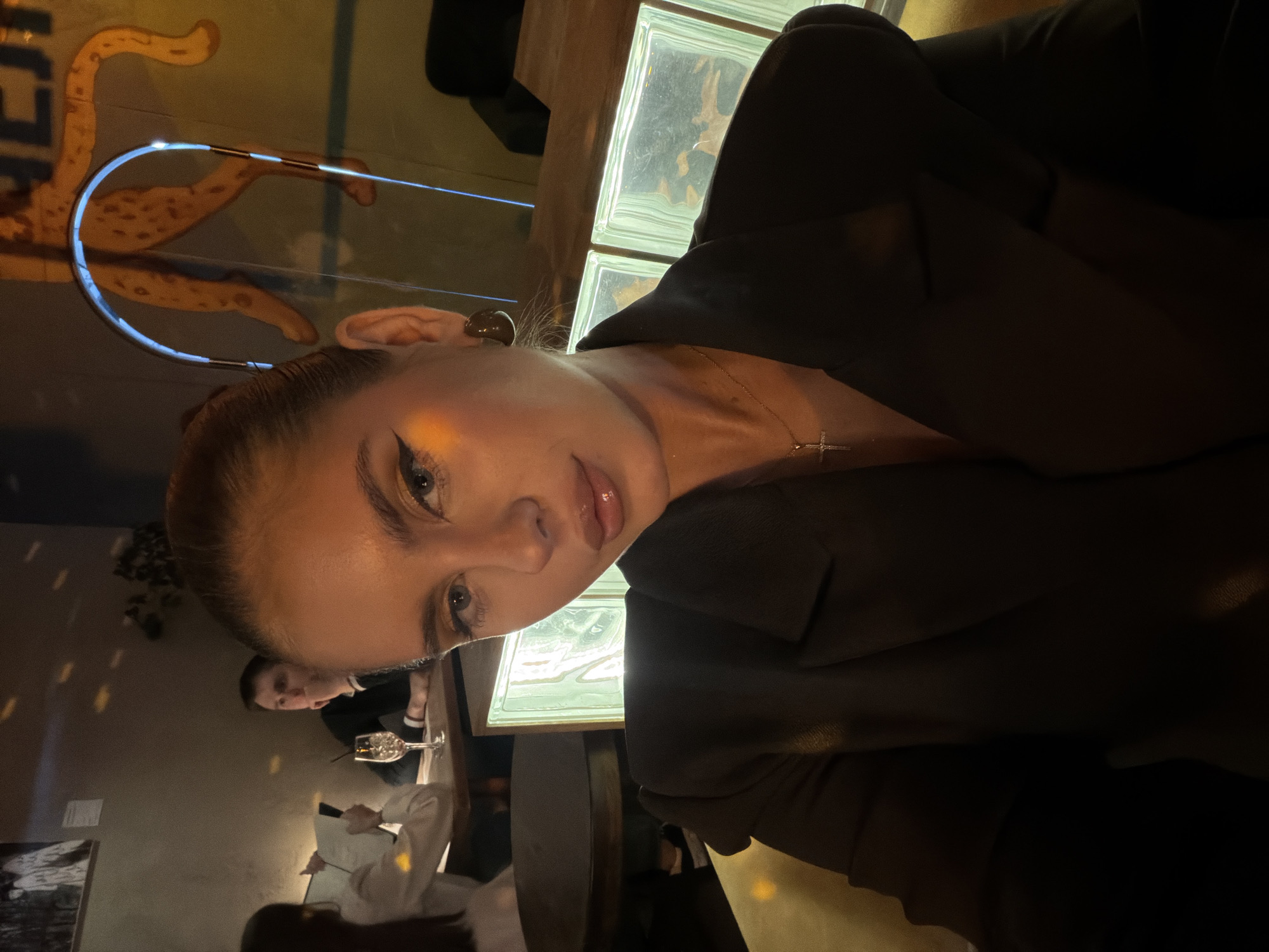 Woman photographs selfie at Krasnoyarsk restaurant