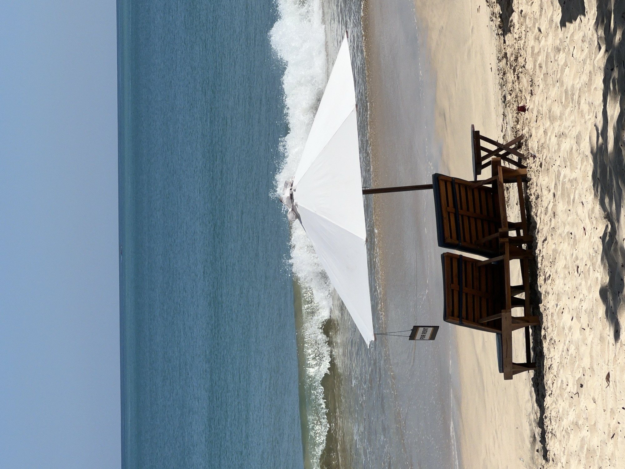 Beach scenes with rental chairs, aircraft, dog captured Kuta Selatan