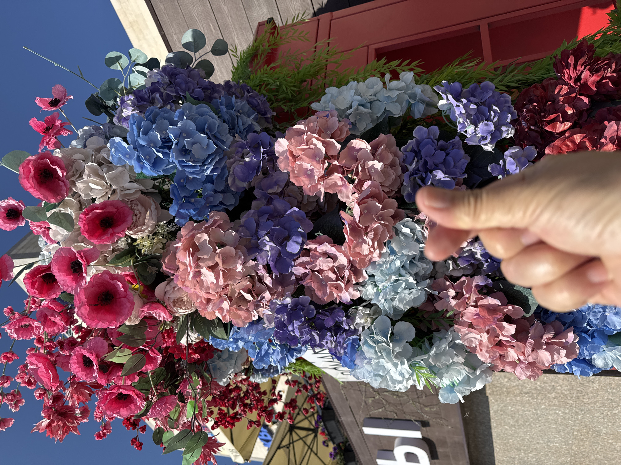 Artificial floral display against blue sky in Kokshetau