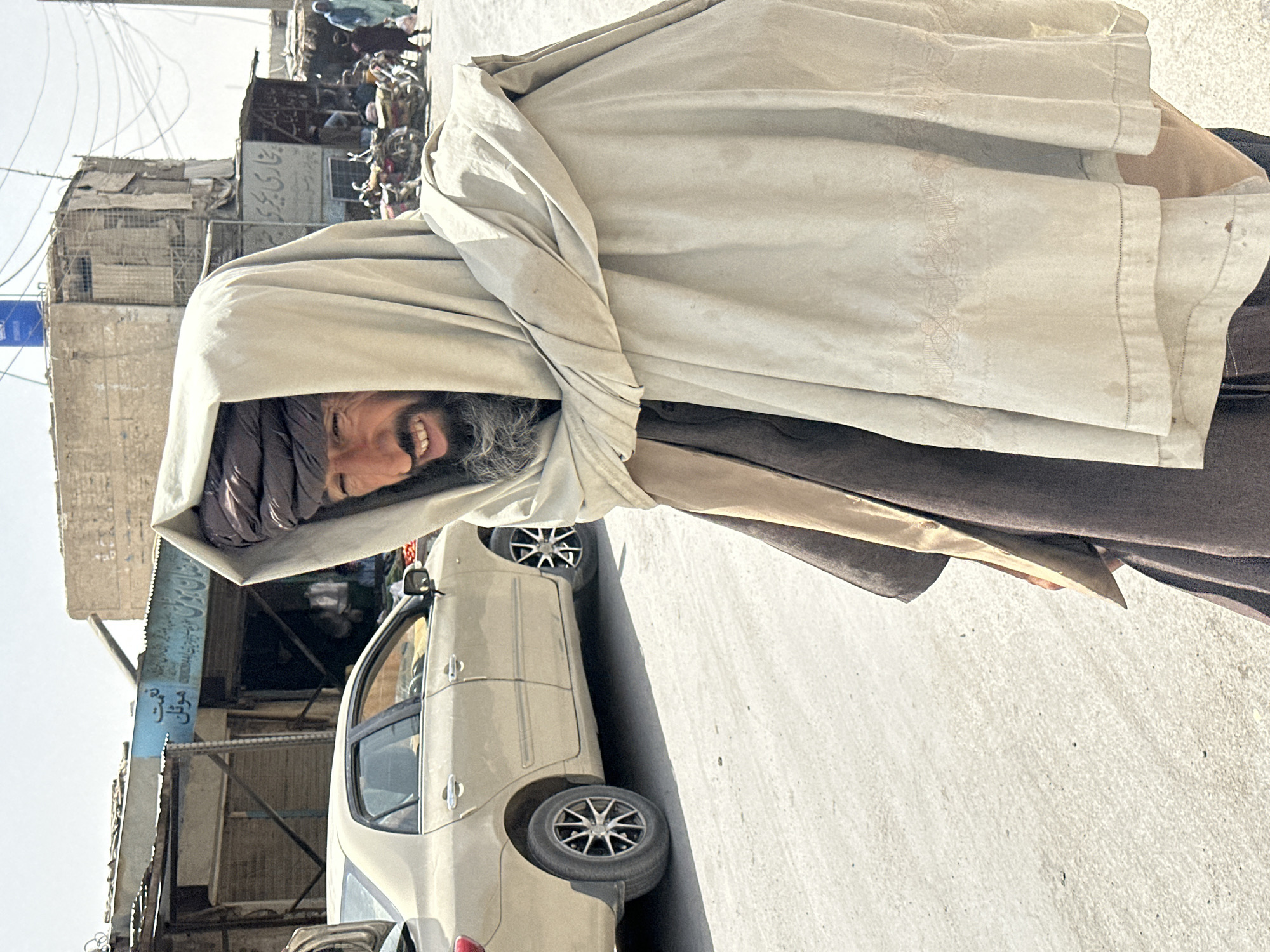 Street life in Chaman, Pakistan — traditional dress, parked motorcycles