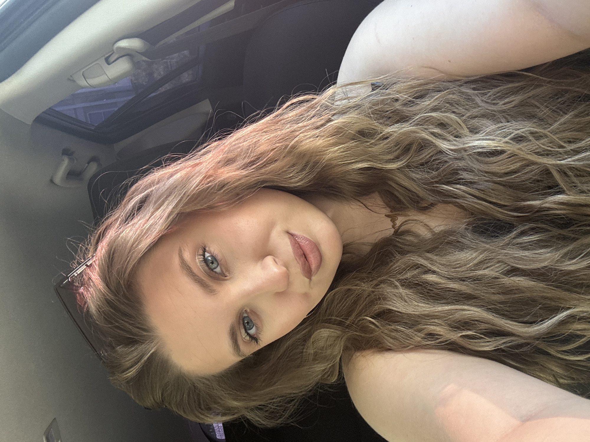 Woman takes morning selfies in car with sunroof in Omsk