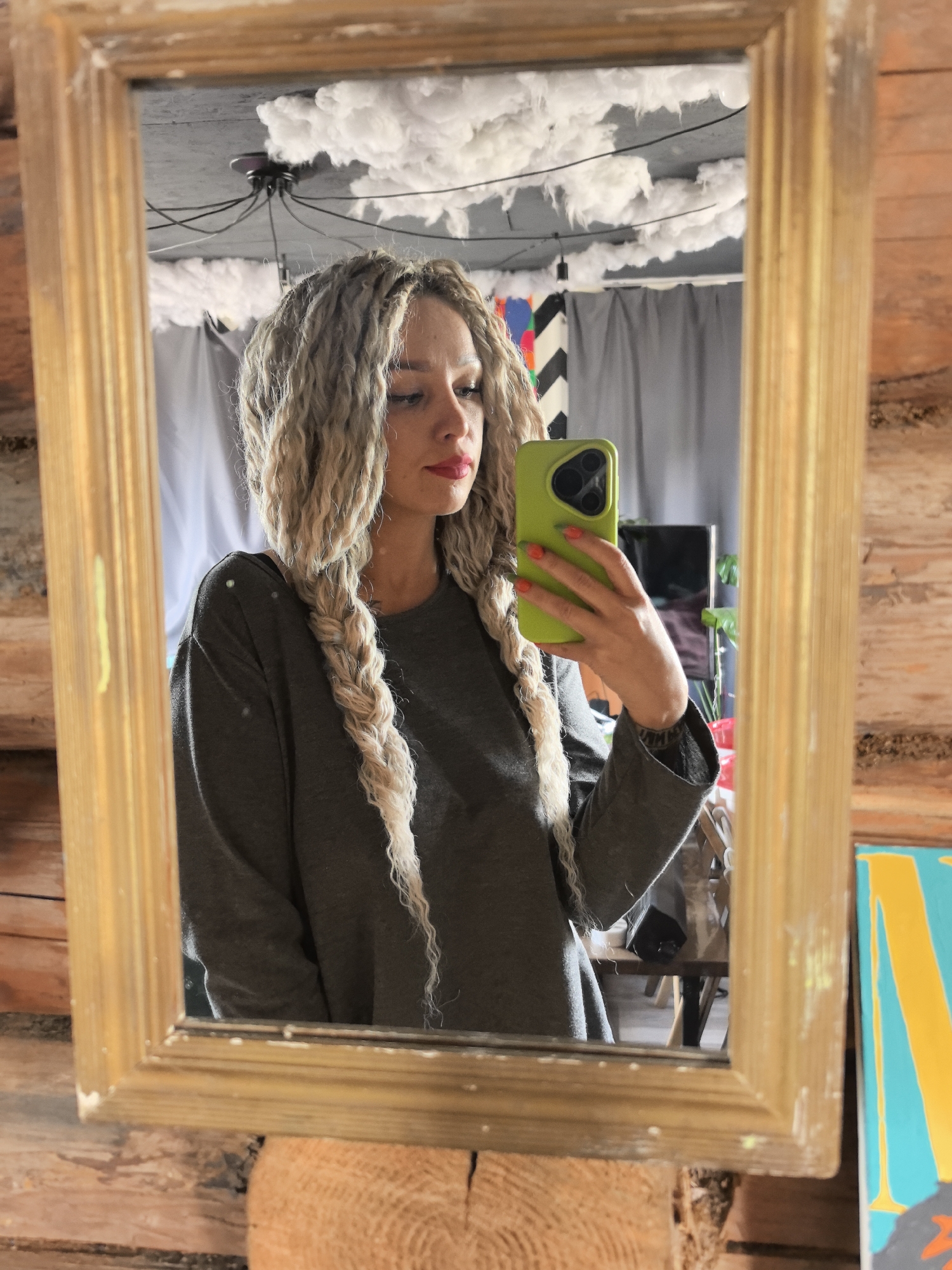 Woman takes mirror selfie with green phone in Russia