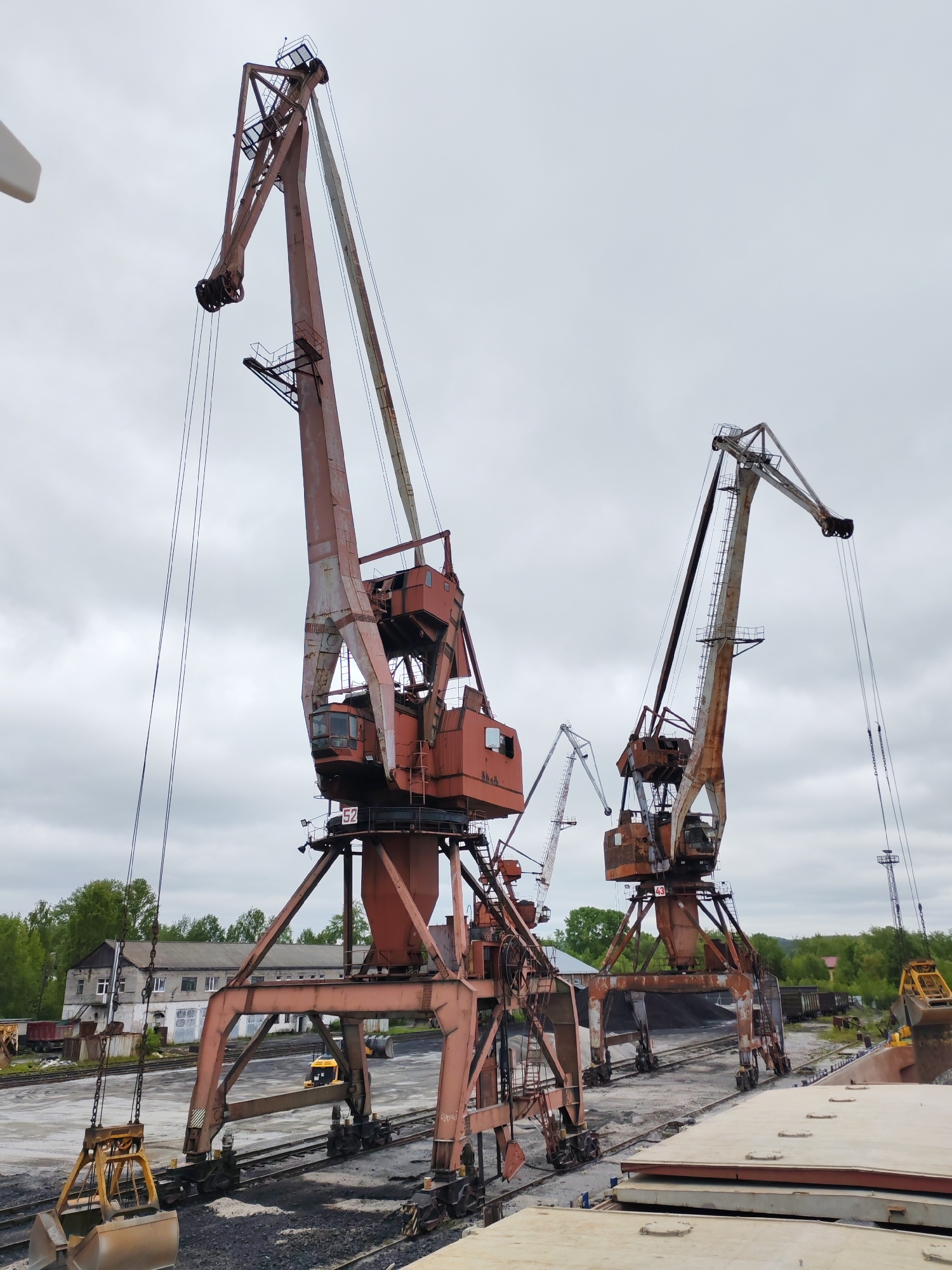 Port cranes operate in overcast Medvezhyegorsk industrial facility