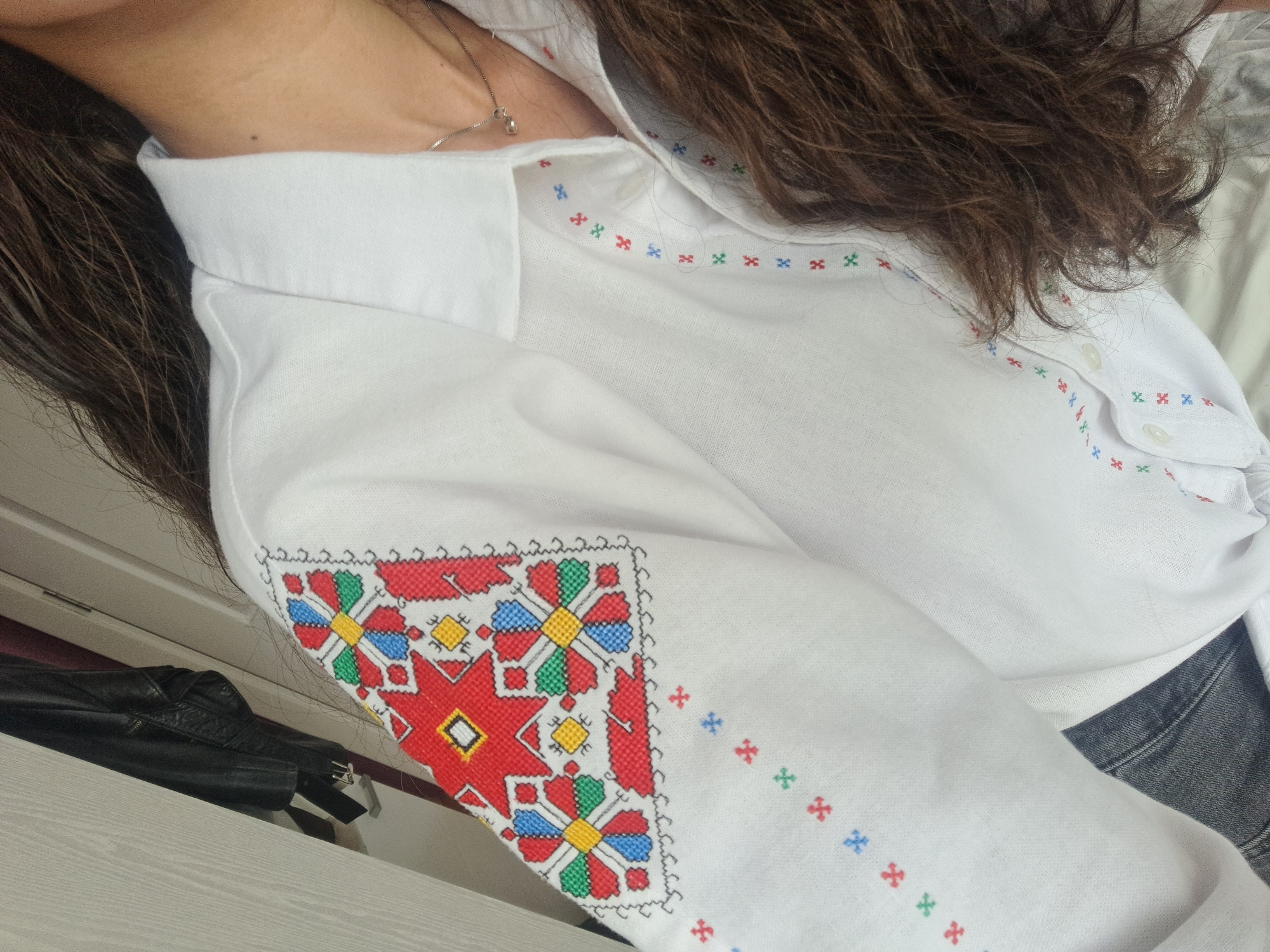 Woman poses with math notes in embroidered shirt