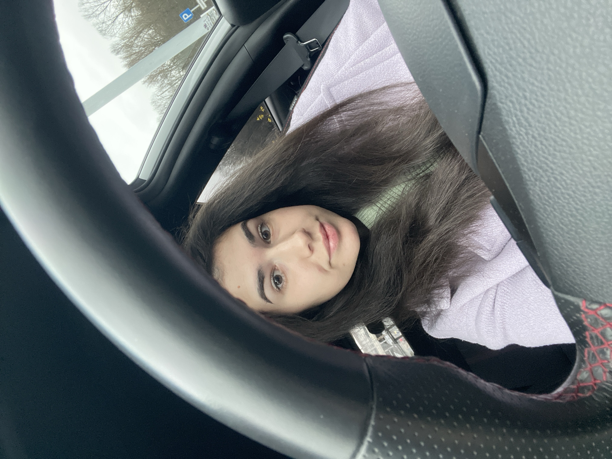 Woman takes early morning car selfie in Sofia