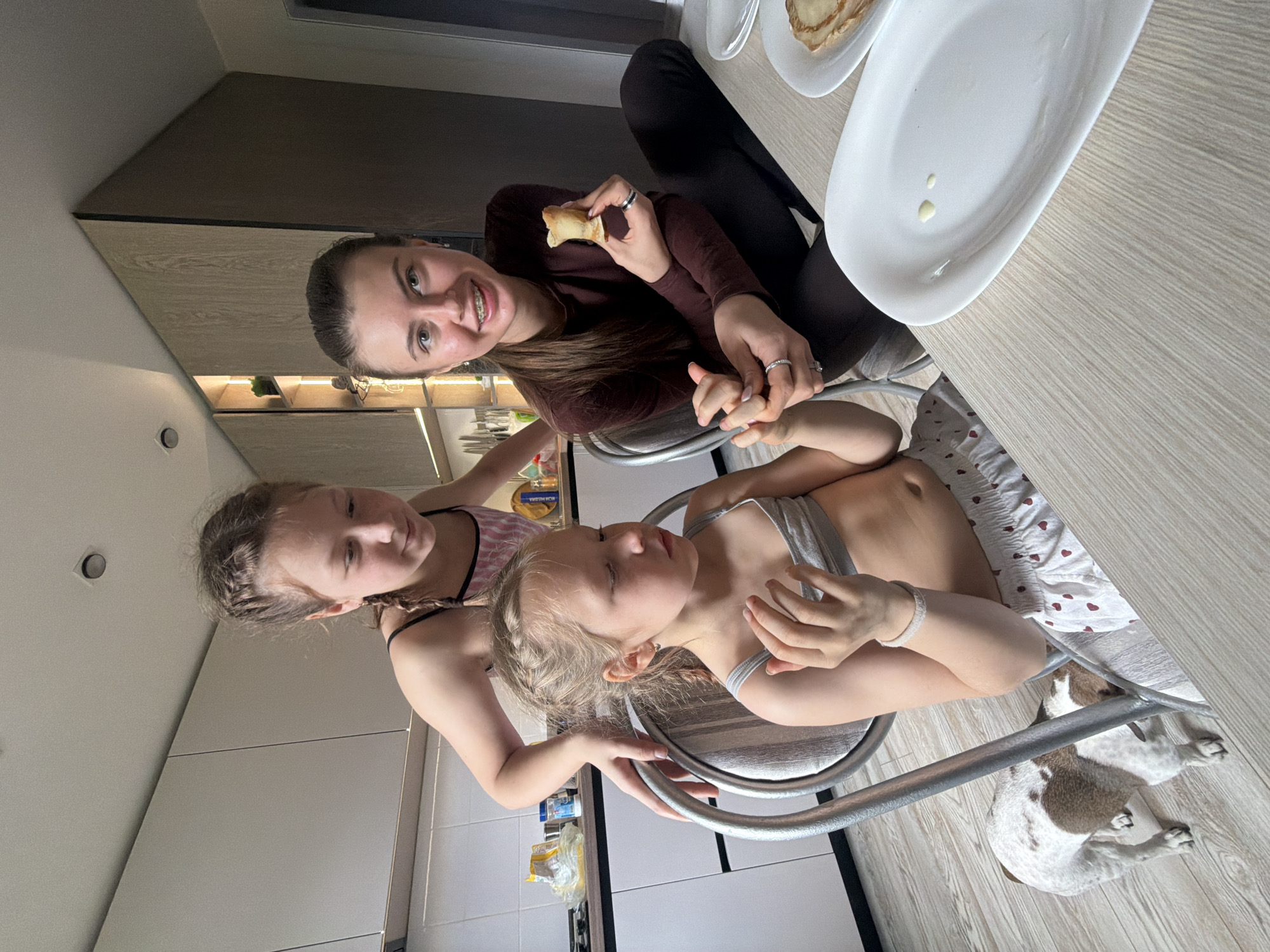 Three girls share morning kitchen moment in Dubovaya