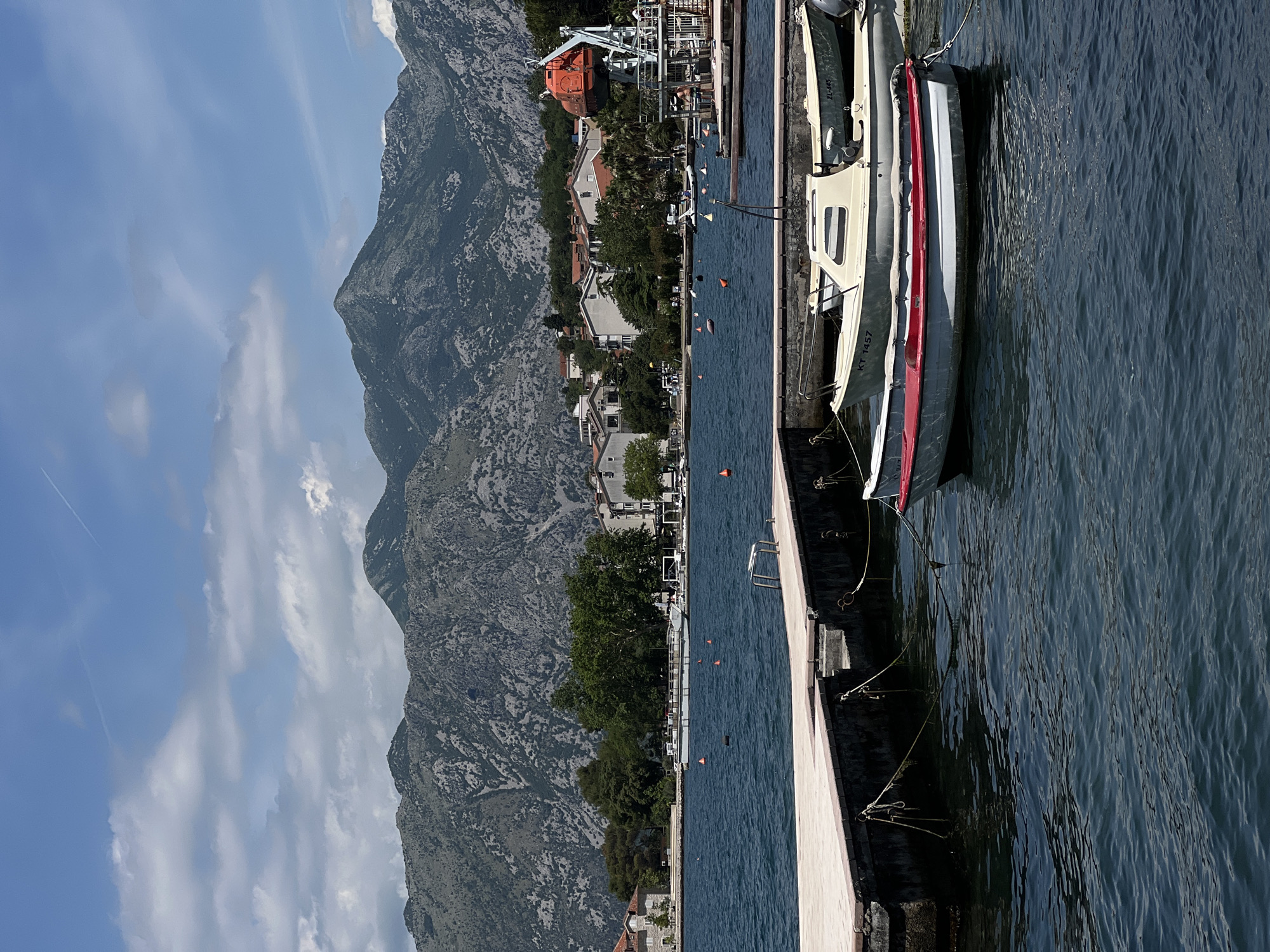 Tourist photographs coastal scenery in Dobrota, Montenegro