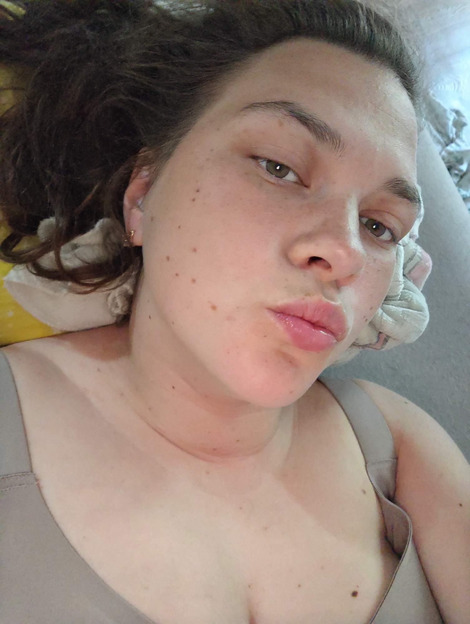 Woman resting on bed observed in Chaikovsky, Russia