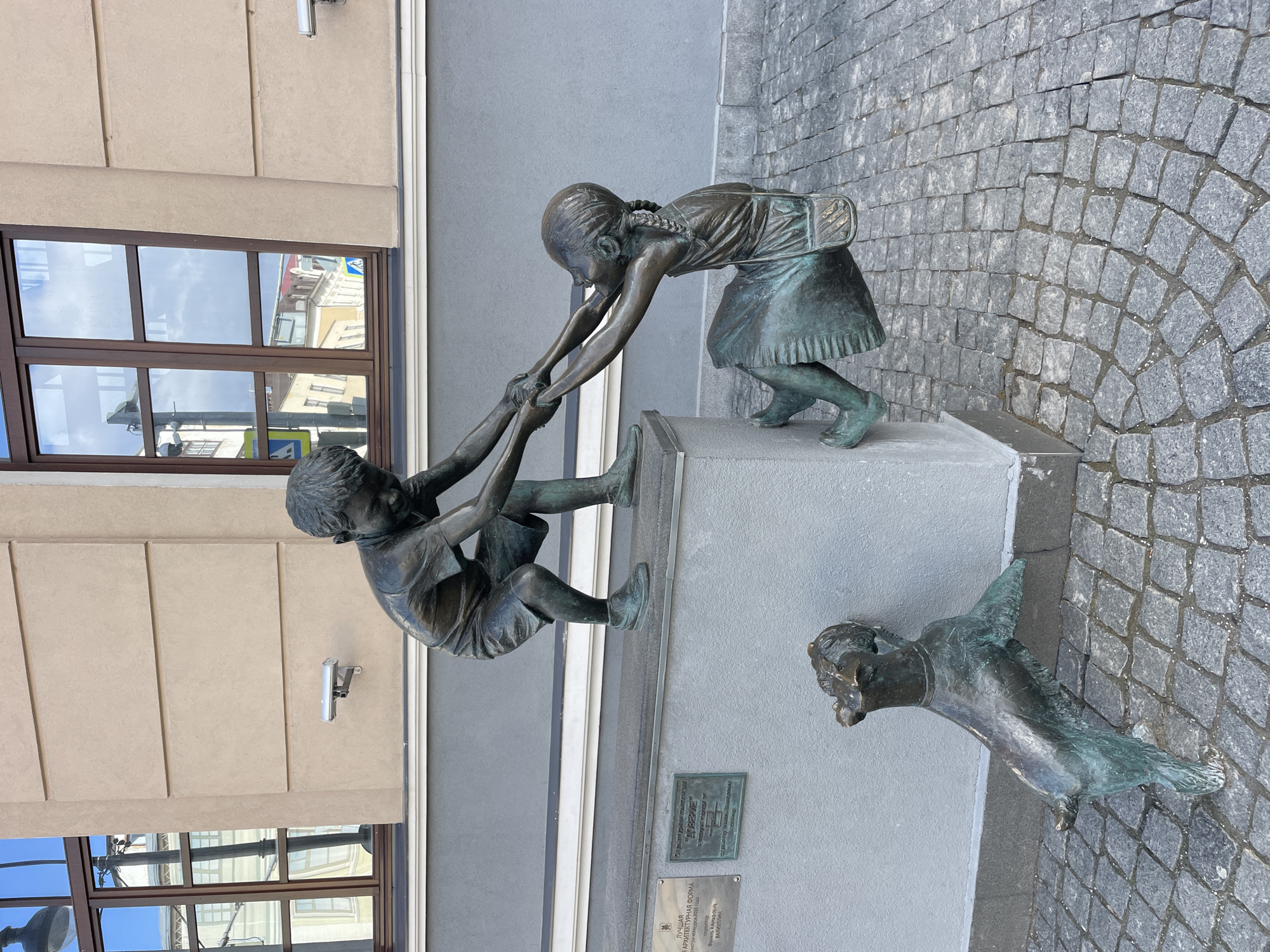 Ordinary day captured on Kazan streets with pedestrians and sculptures