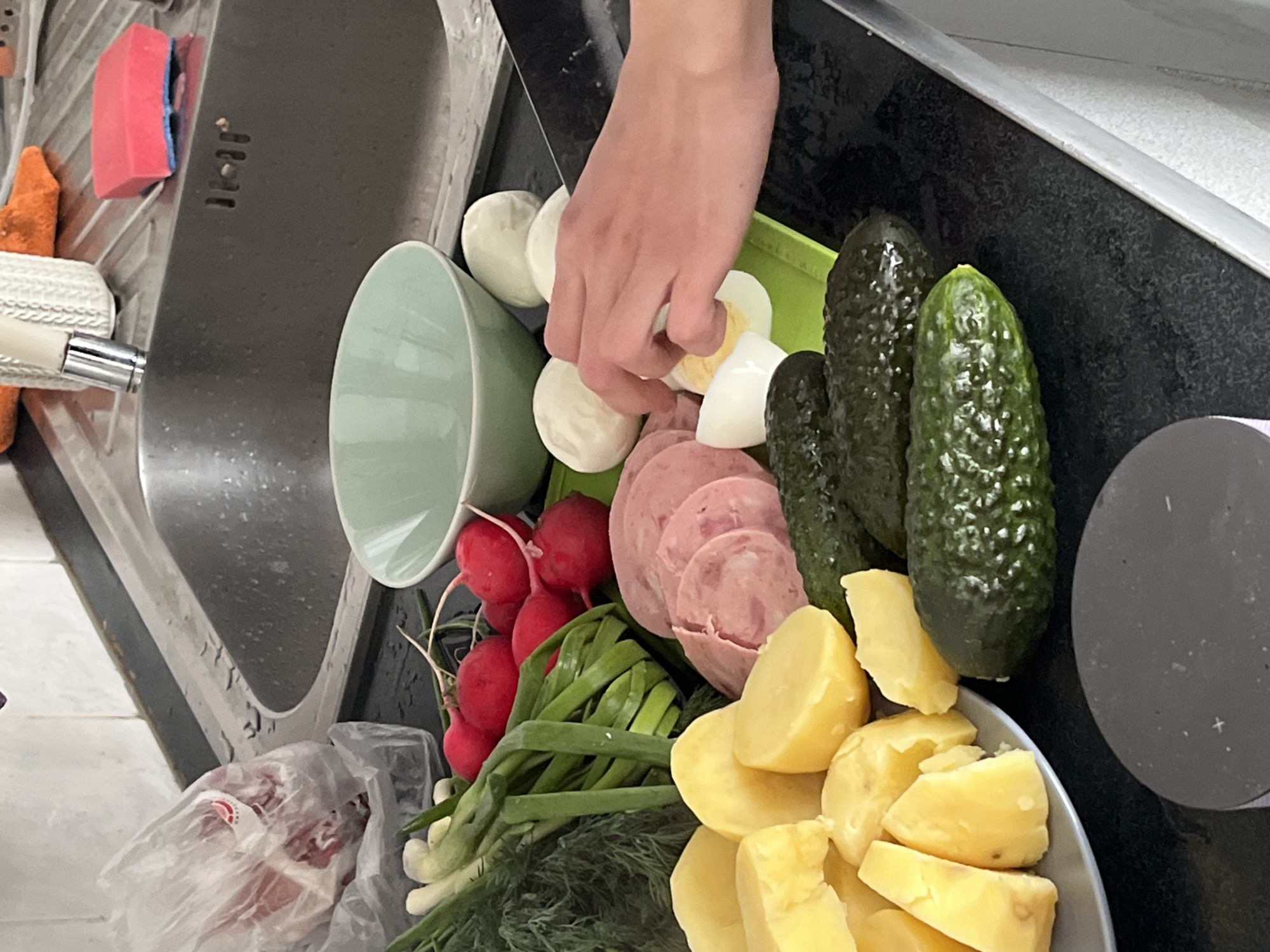 Kitchen food prep documented with salad ingredients, anomalous artwork