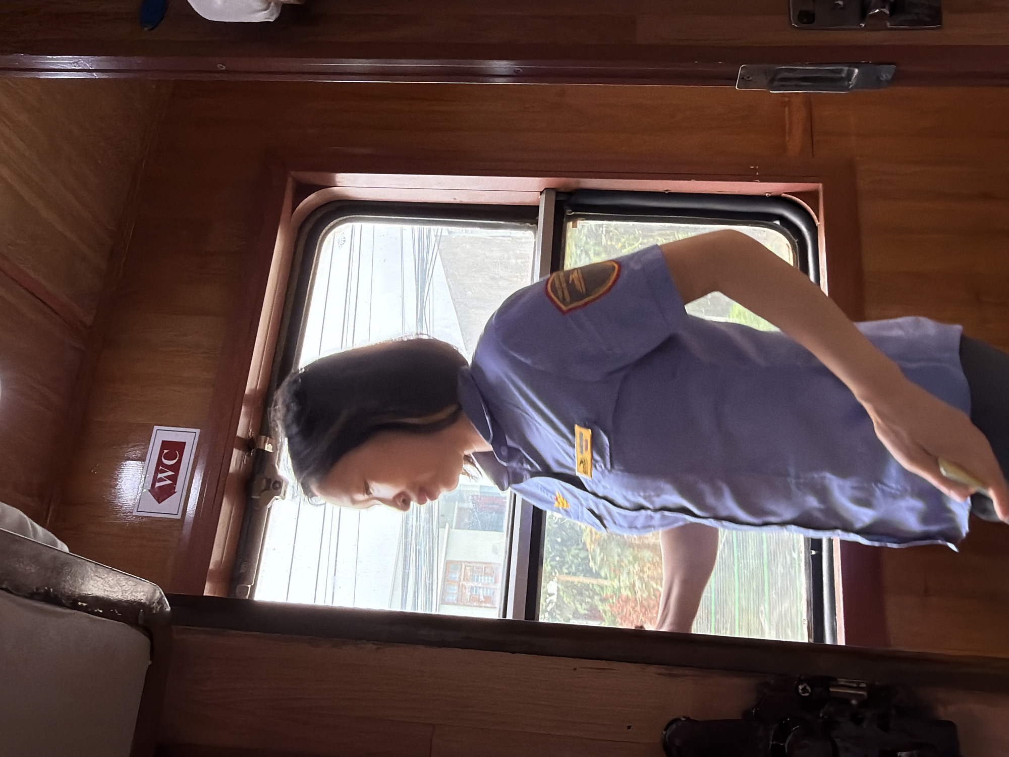 Transit staff looks out a train window in Đà Nẵng