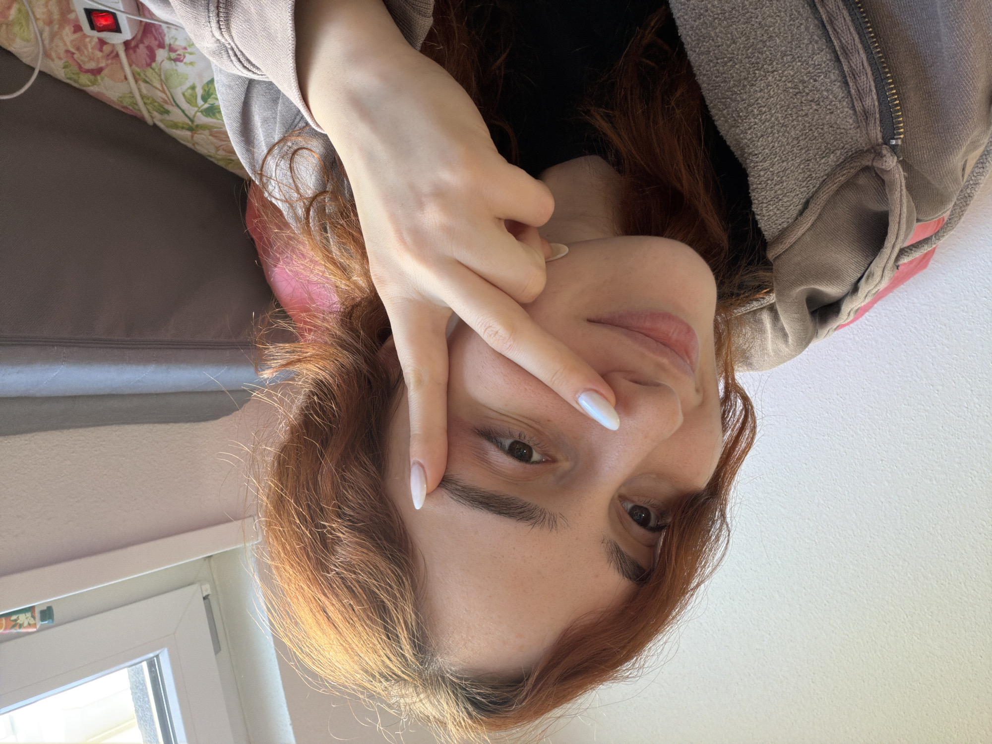 Woman takes playful selfies indoors in Strasbourg
