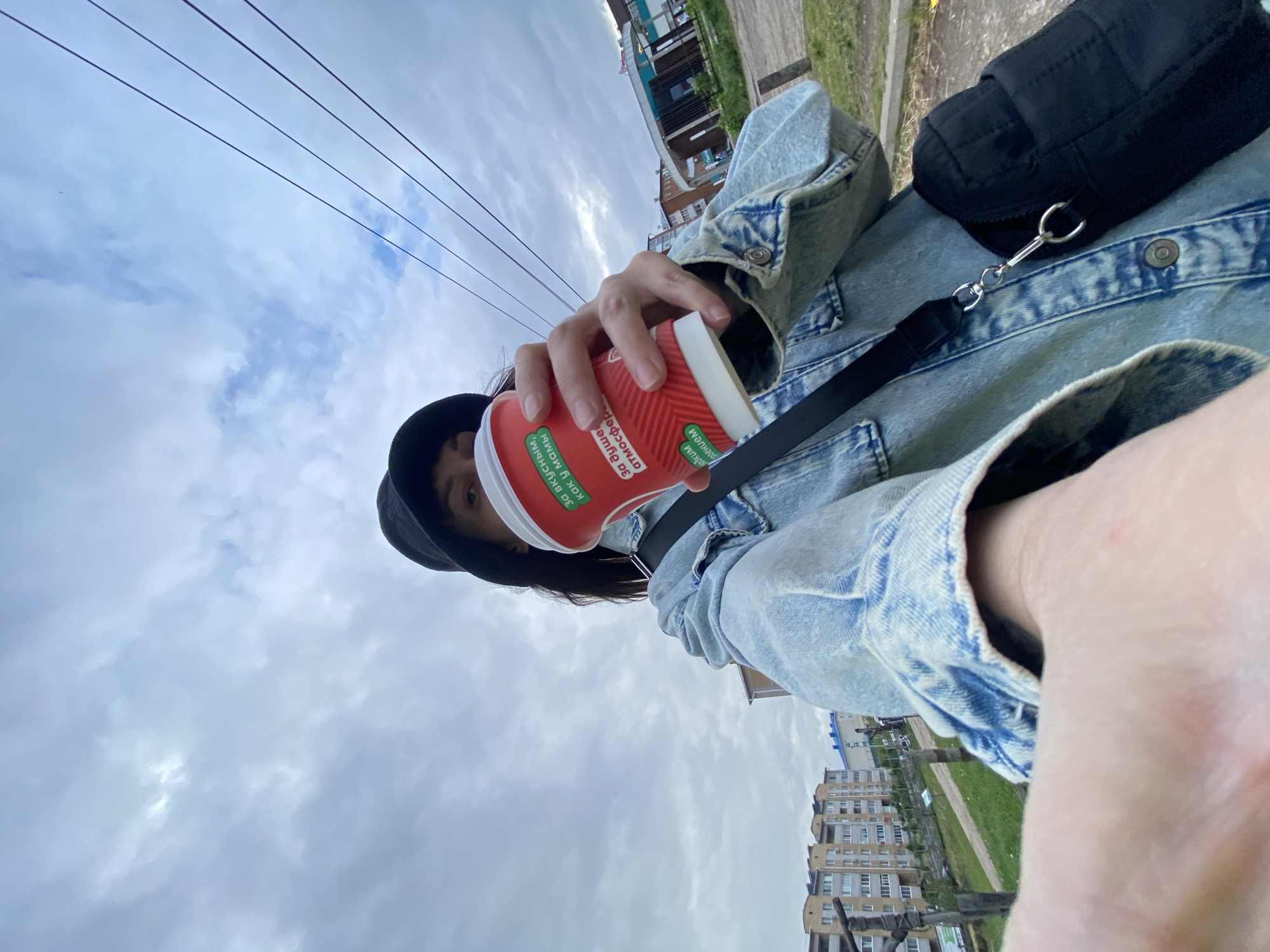 Person with red cup photographed in Votkinsk urban setting