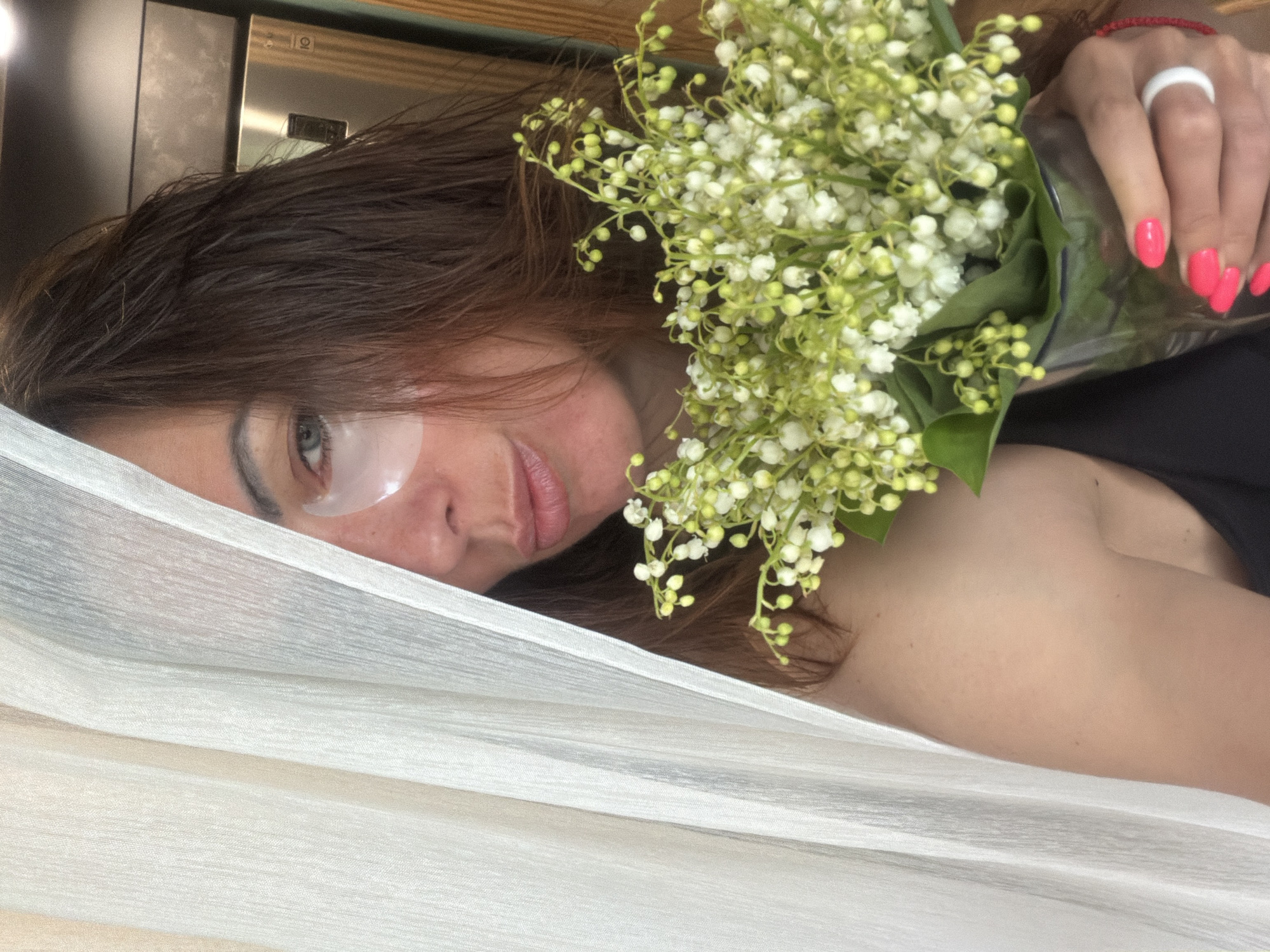 Woman with lilies captured in intimate indoor moments, Birobidzhan