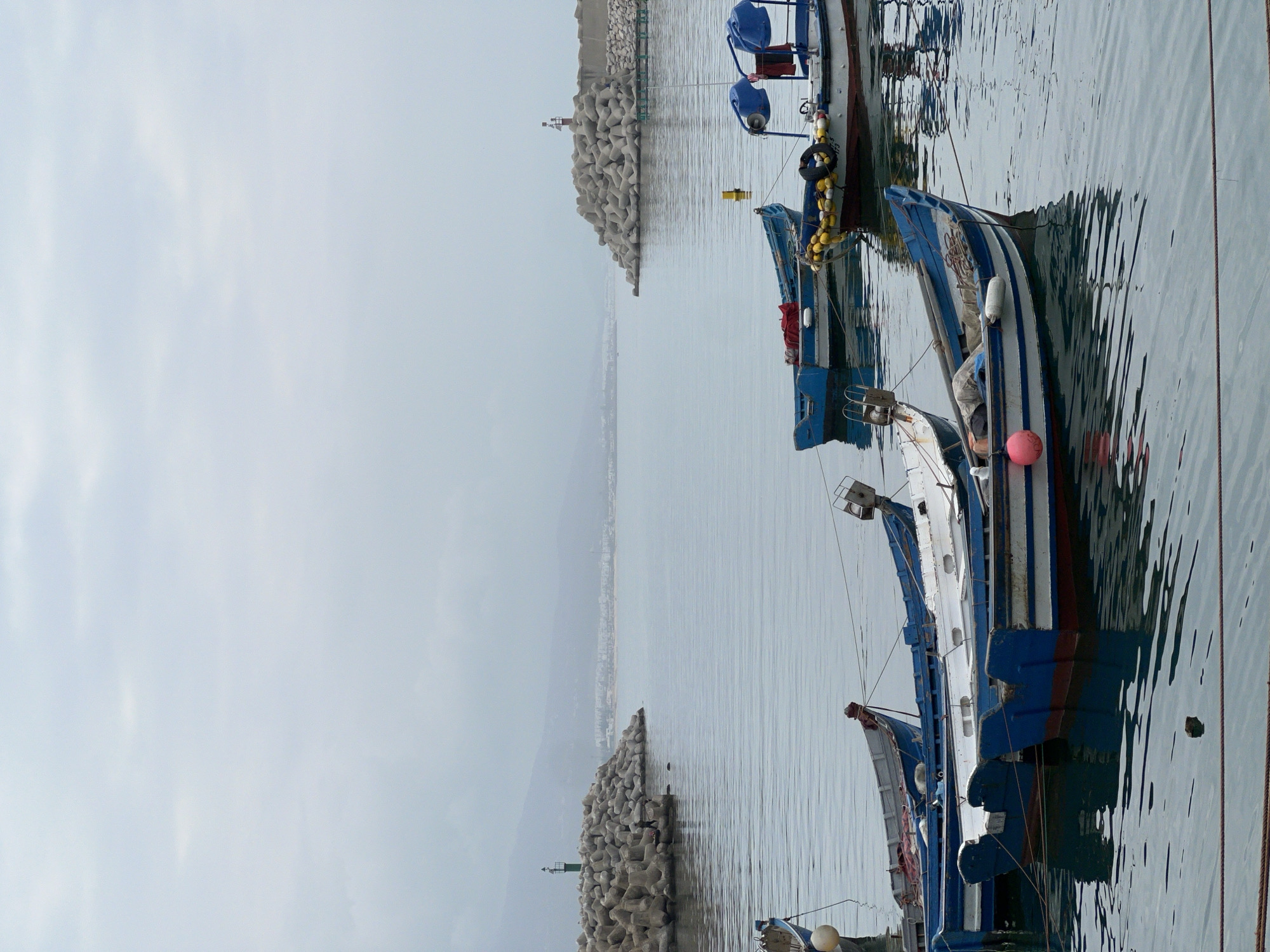 Military patrol boat docked at M'Diq harbor under overcast skies