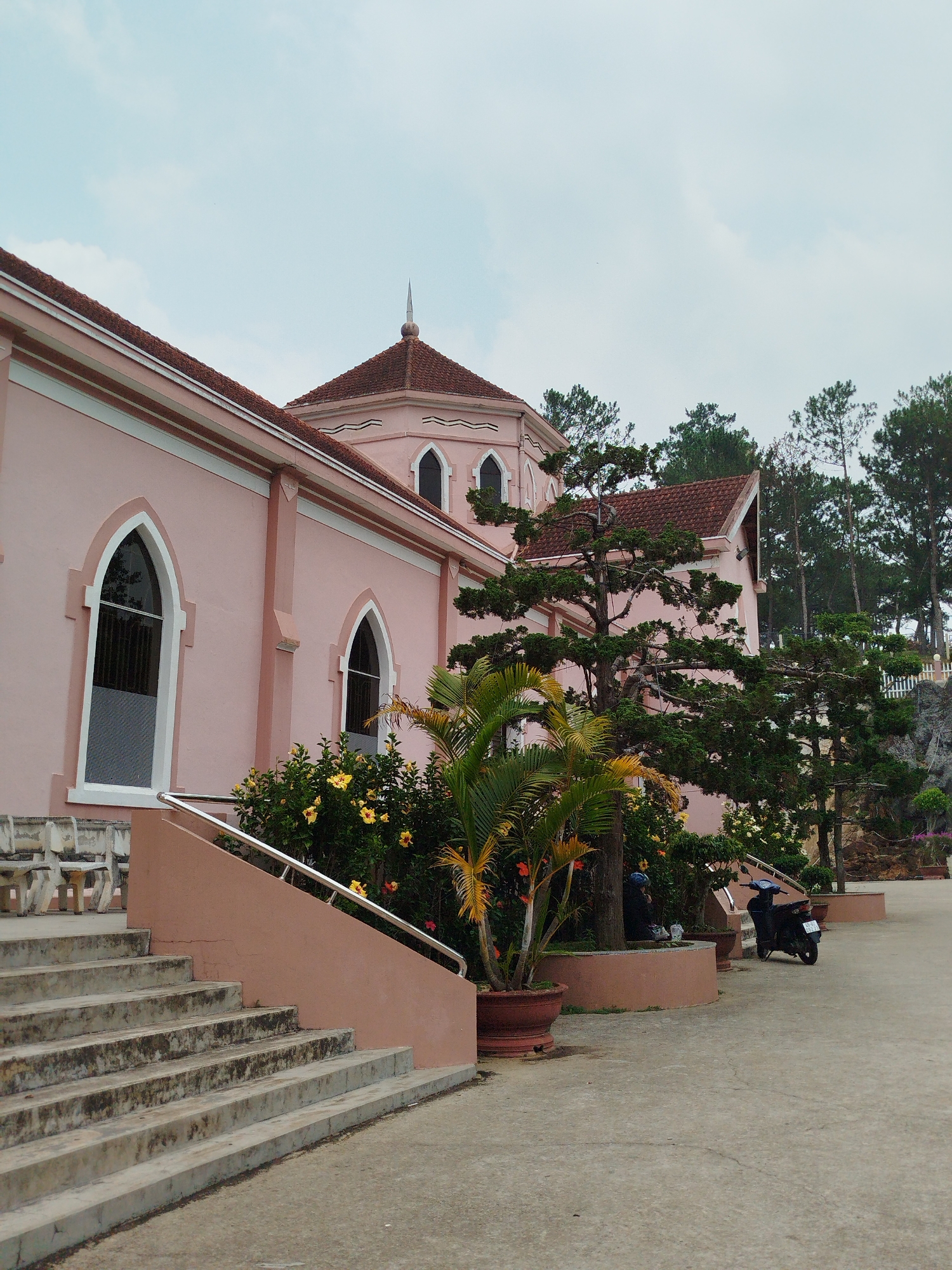 Tourist documents pink Catholic convent grounds in Đà Lạt Vietnam